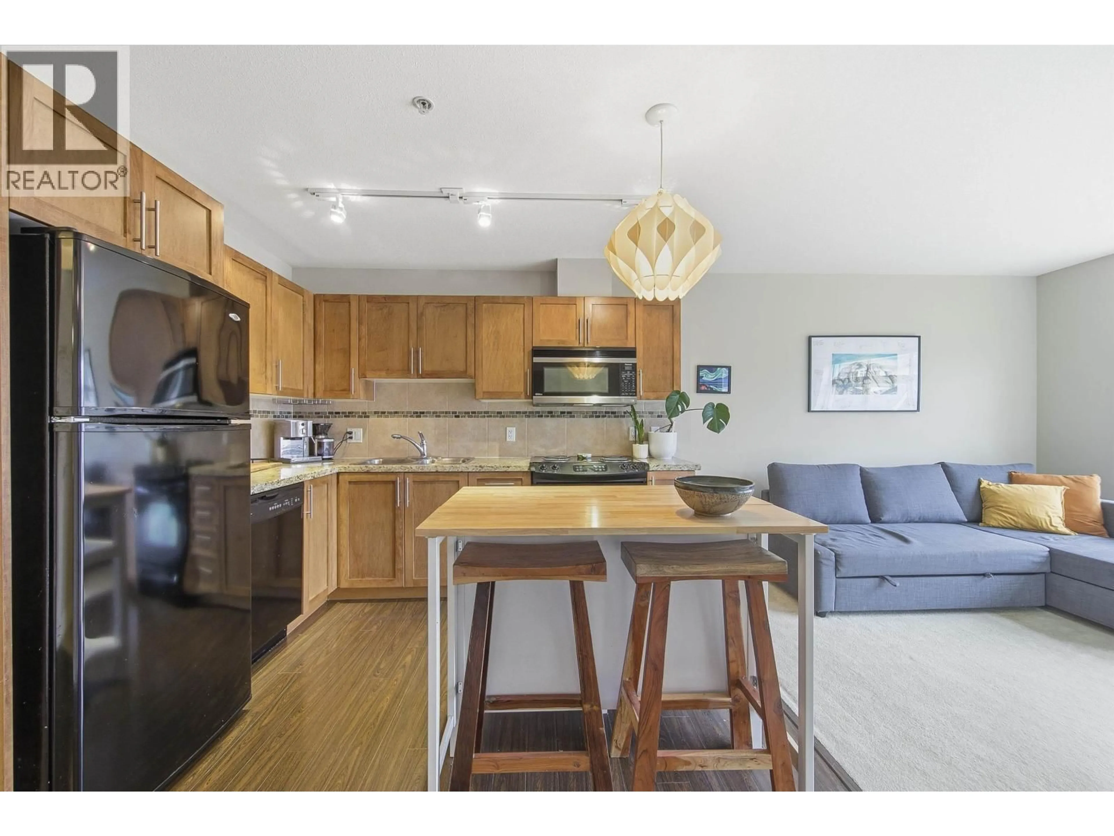 Open concept kitchen, wood/laminate floor for 319 - 1211 VILLAGE GREEN WAY, Squamish British Columbia V8B0R7