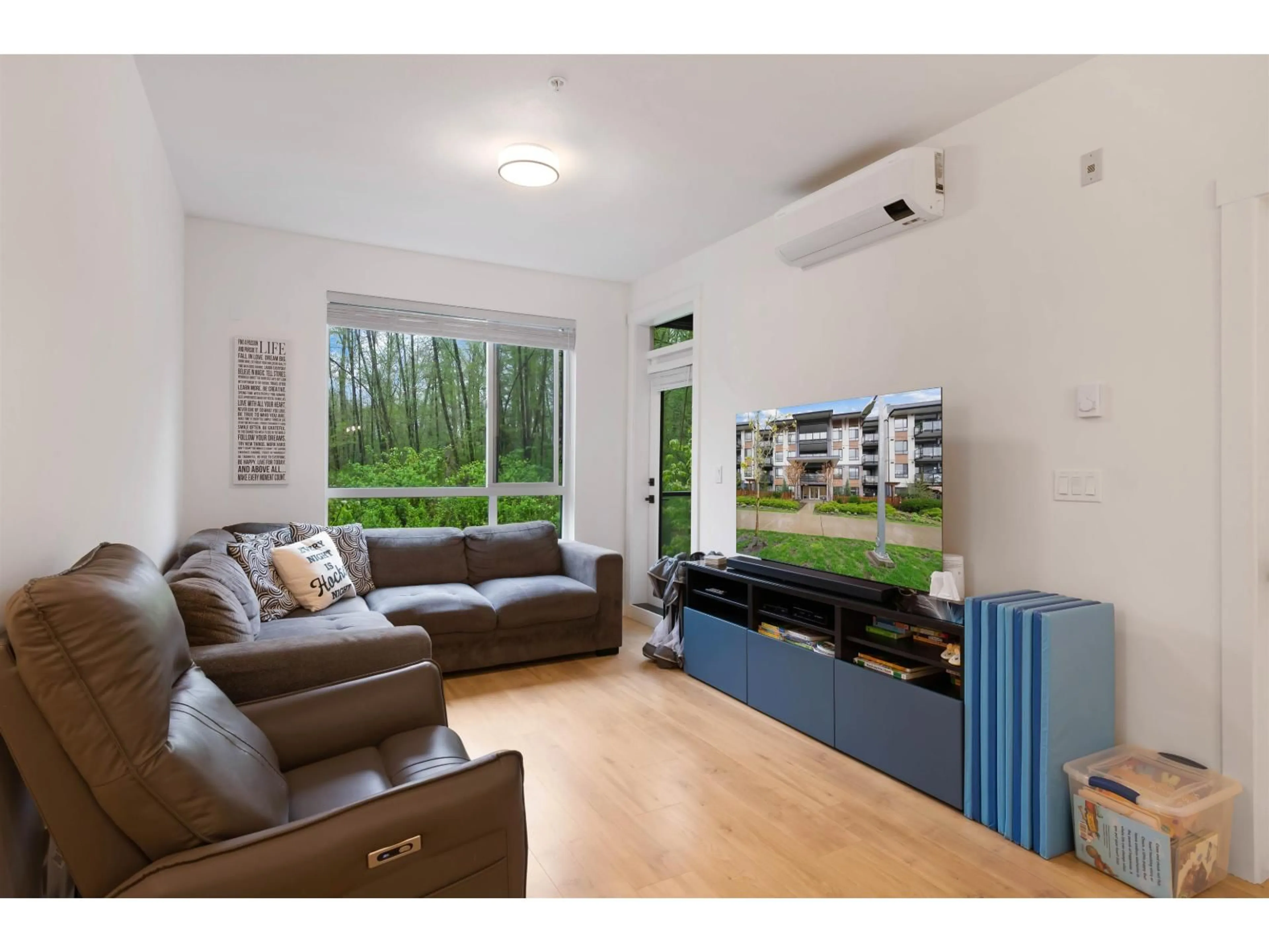 Living room with furniture, wood/laminate floor for 208 - 7506 199A STREET, Langley British Columbia V2Y3K9