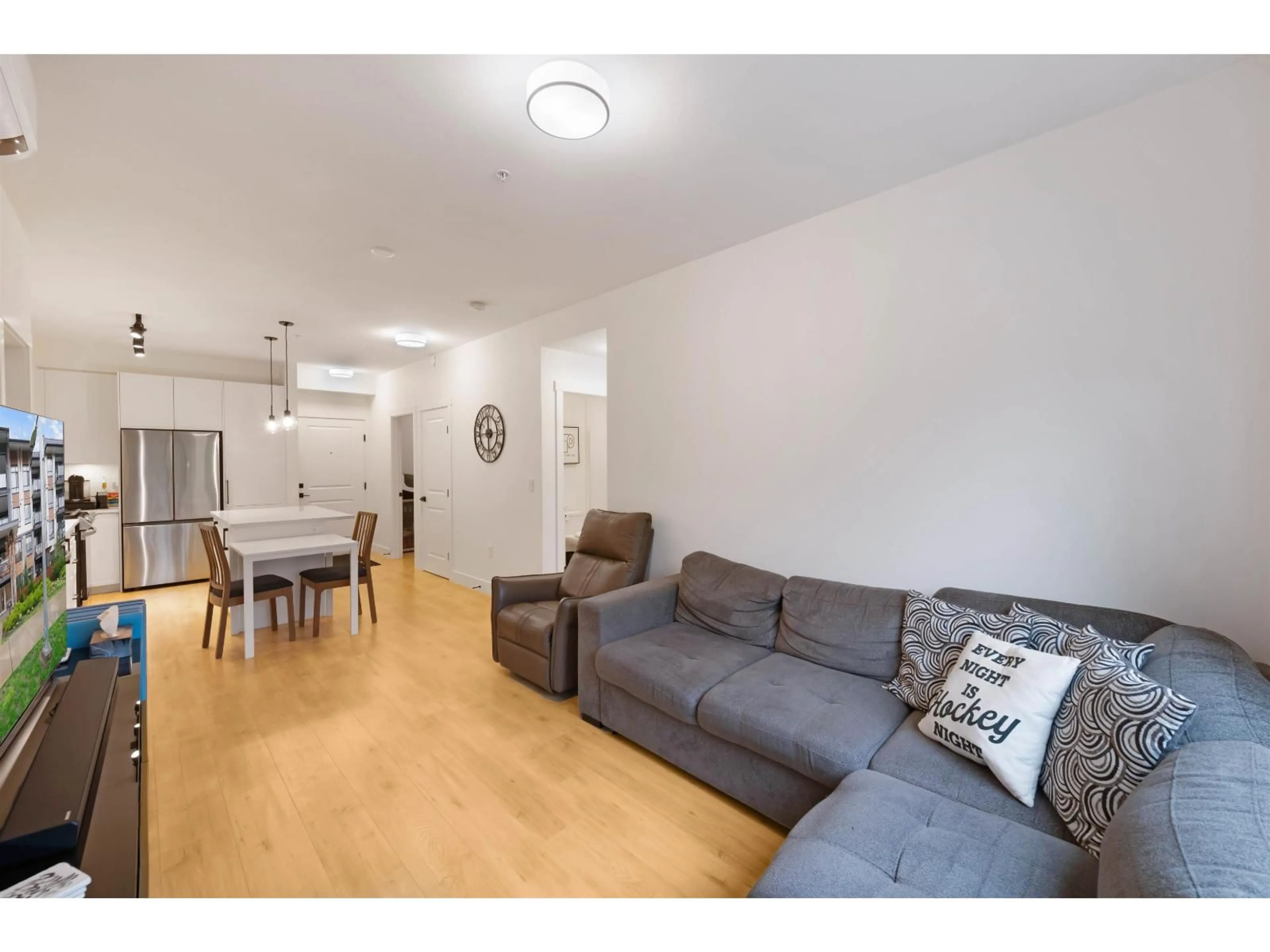 Living room with furniture, wood/laminate floor for 208 - 7506 199A STREET, Langley British Columbia V2Y3K9