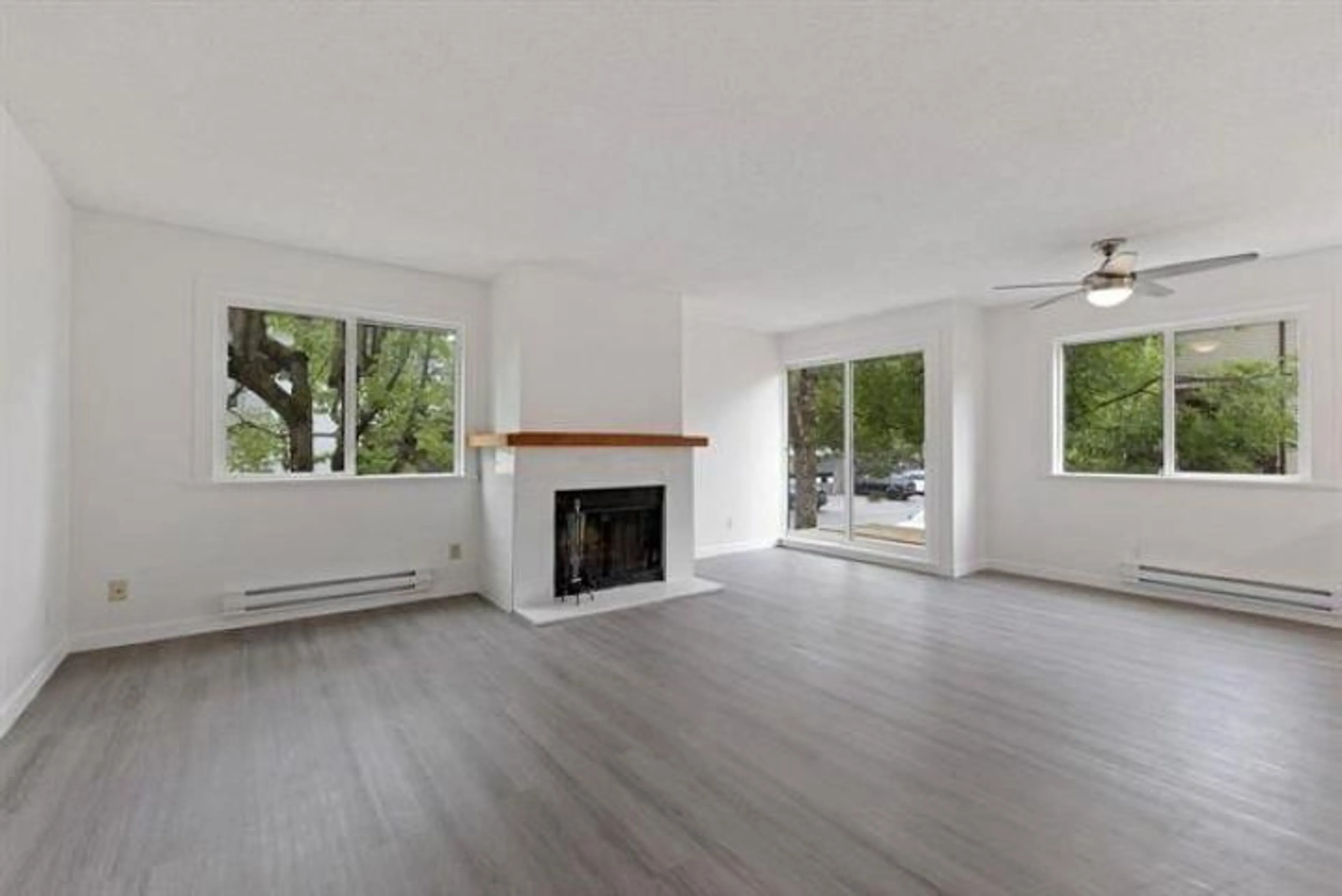 Living room with furniture, wood/laminate floor for 204 - 7120 133 STREET, Surrey British Columbia V3W1Z7