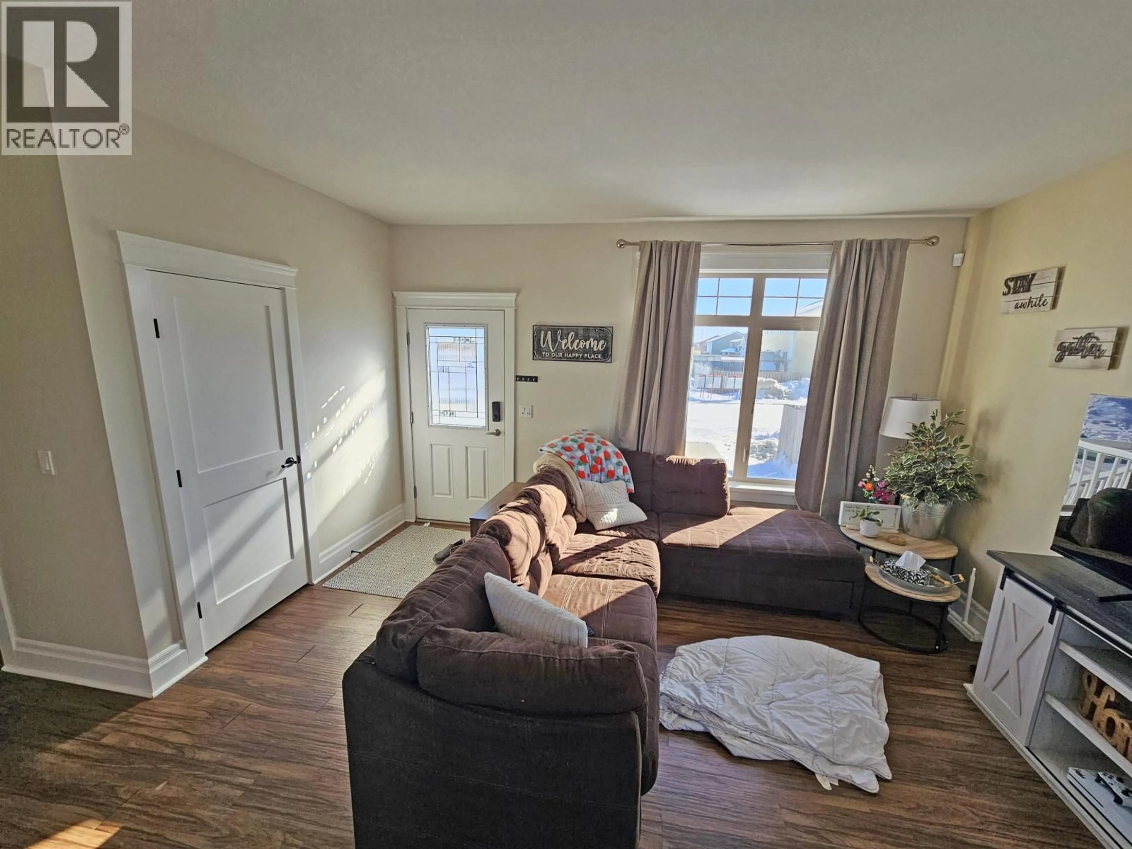 Living room with furniture, wood/laminate floor for 8616 84 STREET, Fort St. John British Columbia V1J0K8