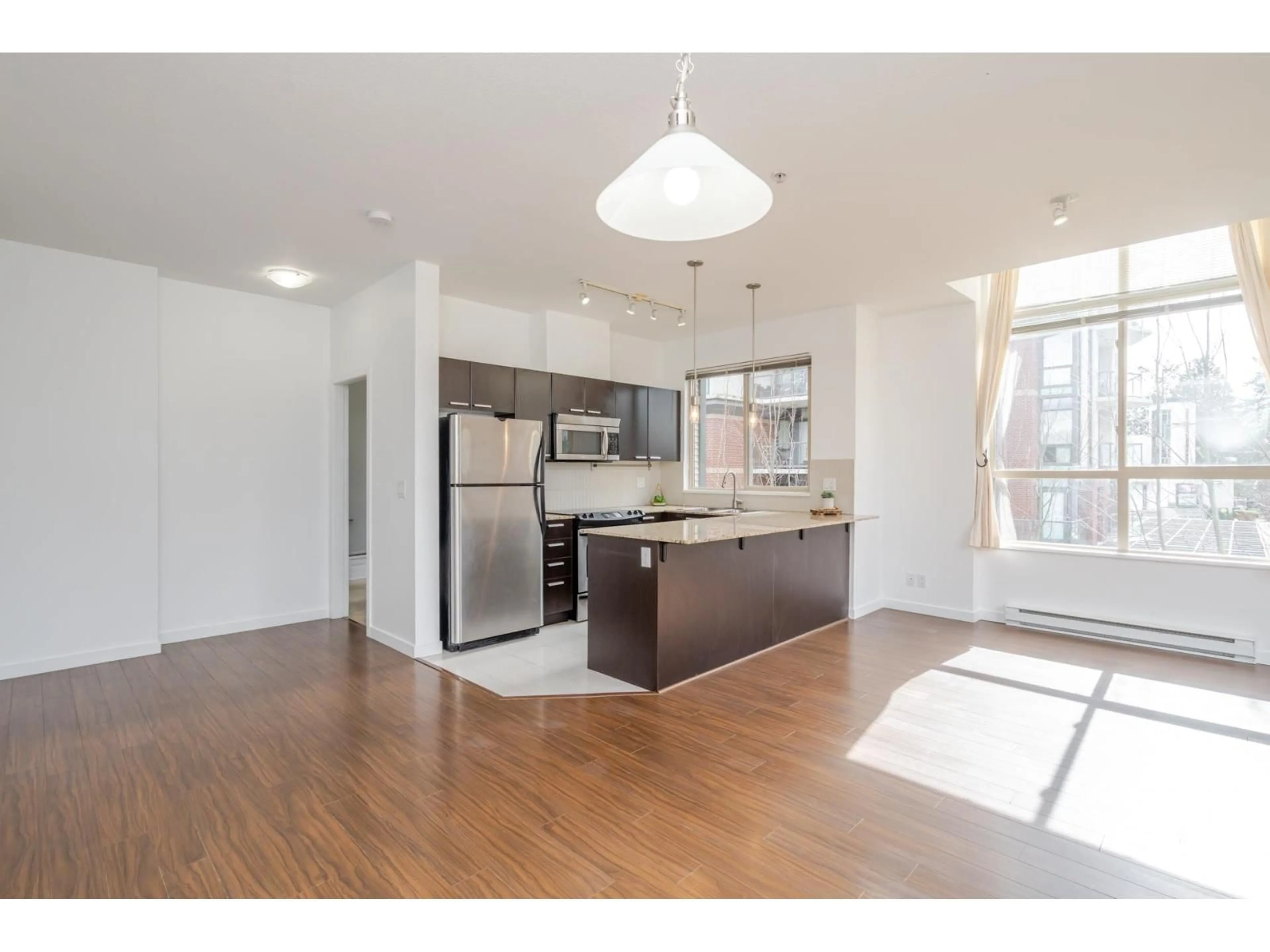 Open concept kitchen, wood/laminate floor for 405 - 10455 UNIVERSITY DRIVE, Surrey British Columbia V3T0A5
