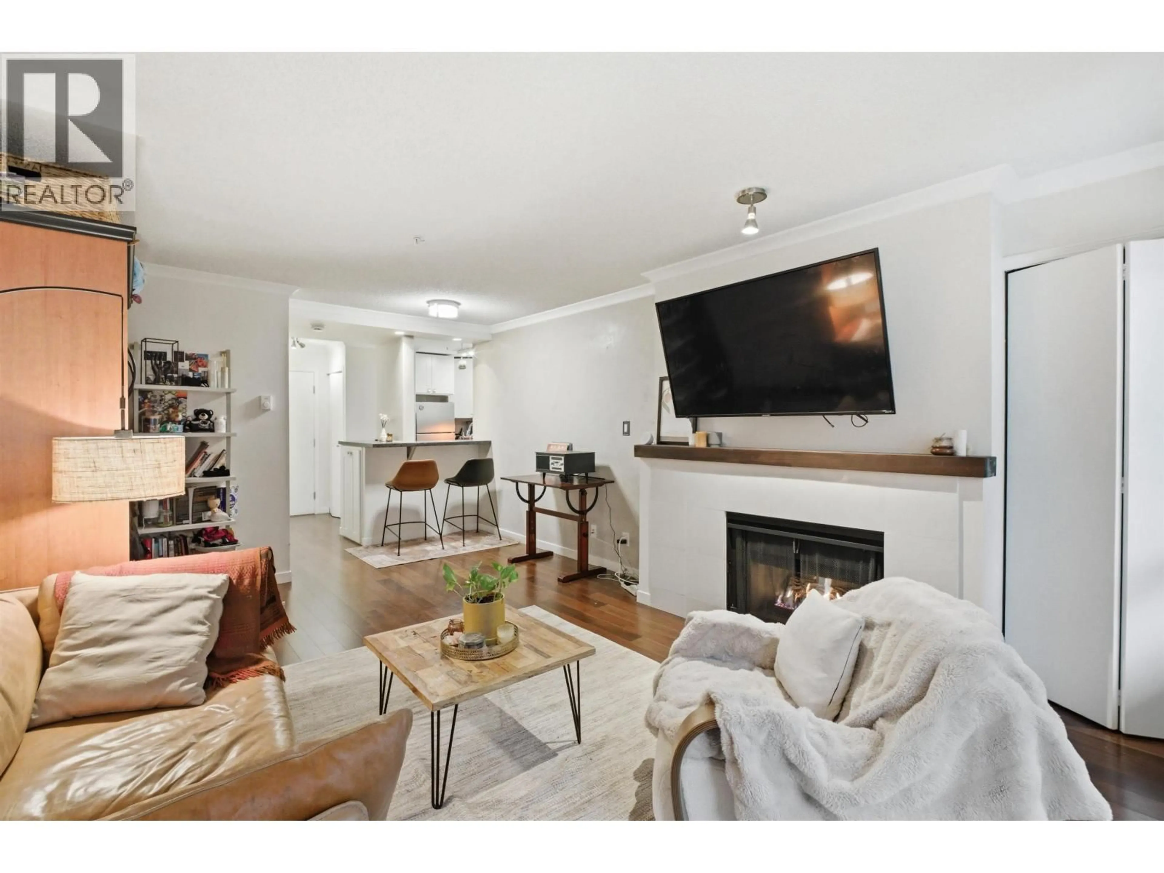 Living room with furniture, wood/laminate floor for 307 - 1230 HARO STREET, Vancouver British Columbia V6E4J9