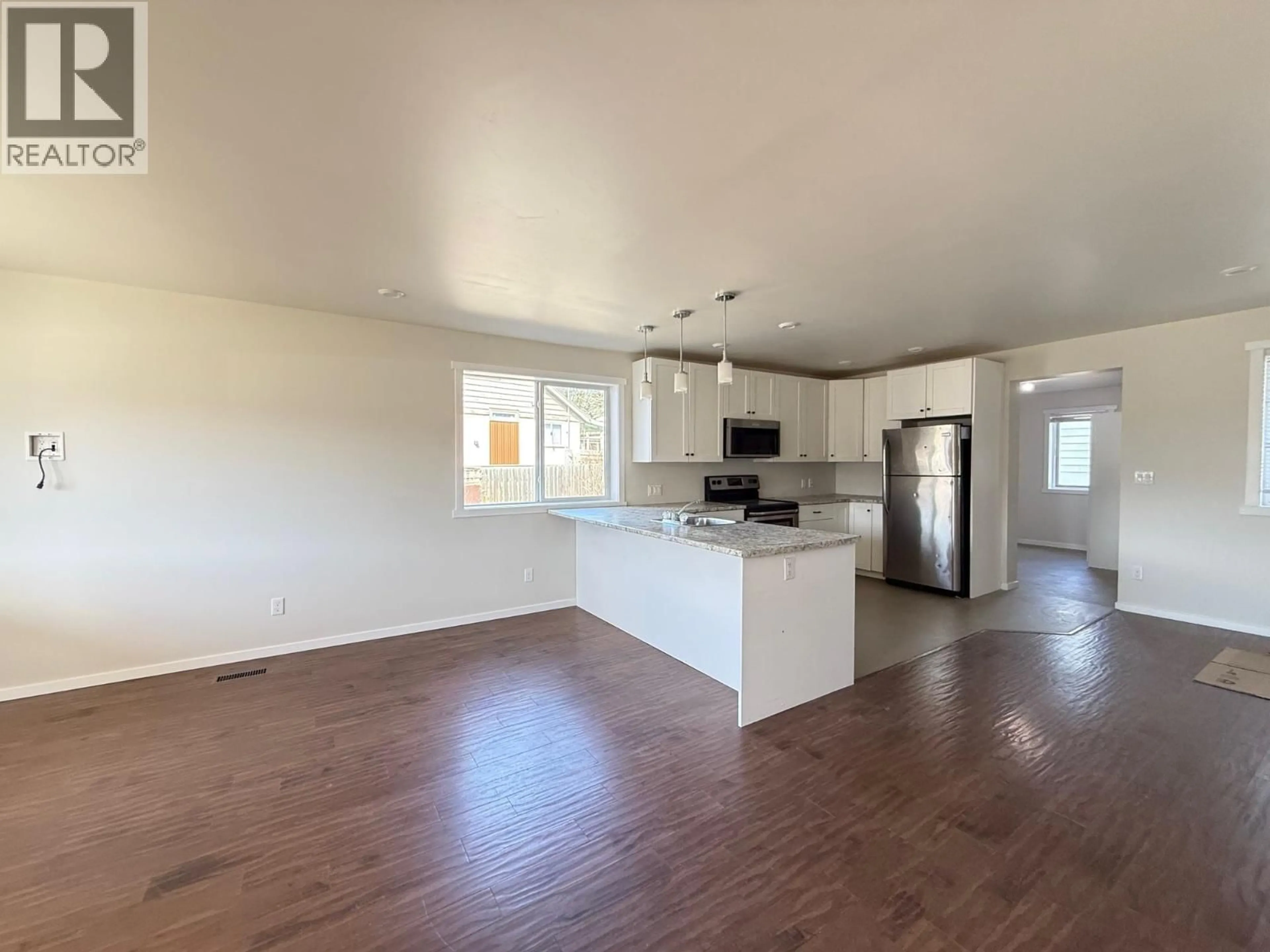 Open concept kitchen, wood/laminate floor for 252 FOURTH AVENUE, Williams Lake British Columbia V2G2E1