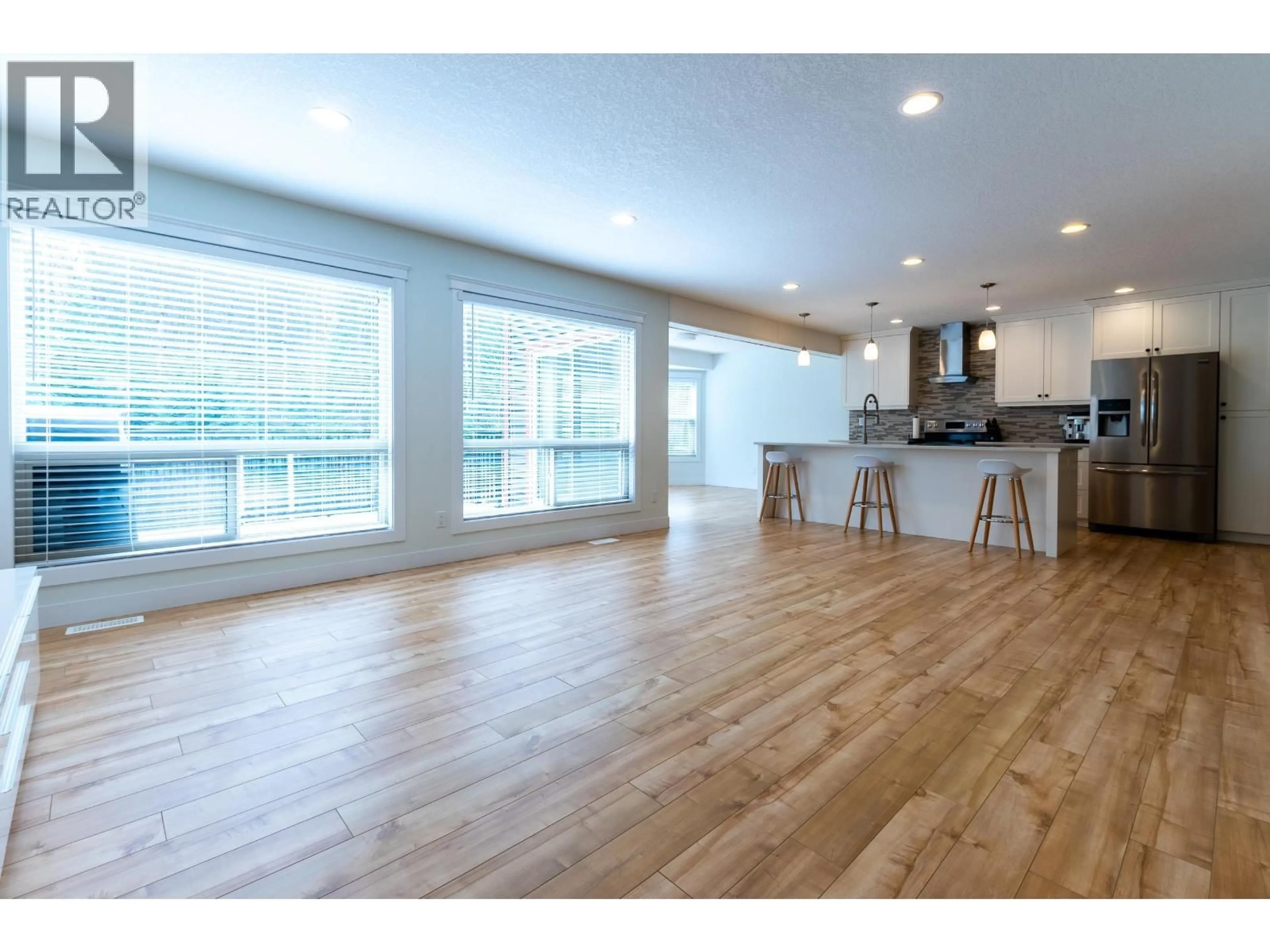 Open concept kitchen, wood/laminate floor for 8009 STILLWATER CRESCENT, Prince George British Columbia V2N0C2