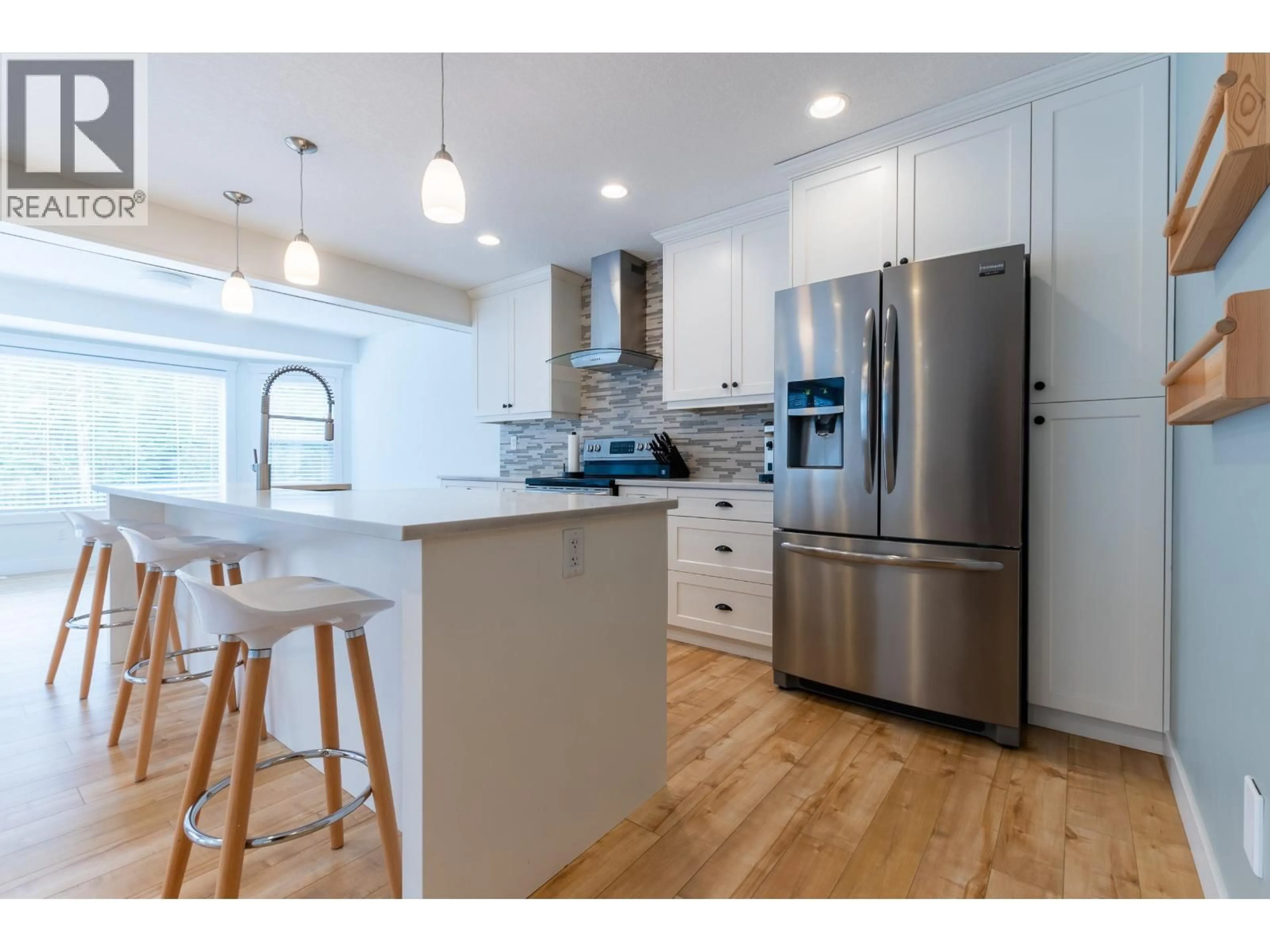 Open concept kitchen, wood/laminate floor for 8009 STILLWATER CRESCENT, Prince George British Columbia V2N0C2