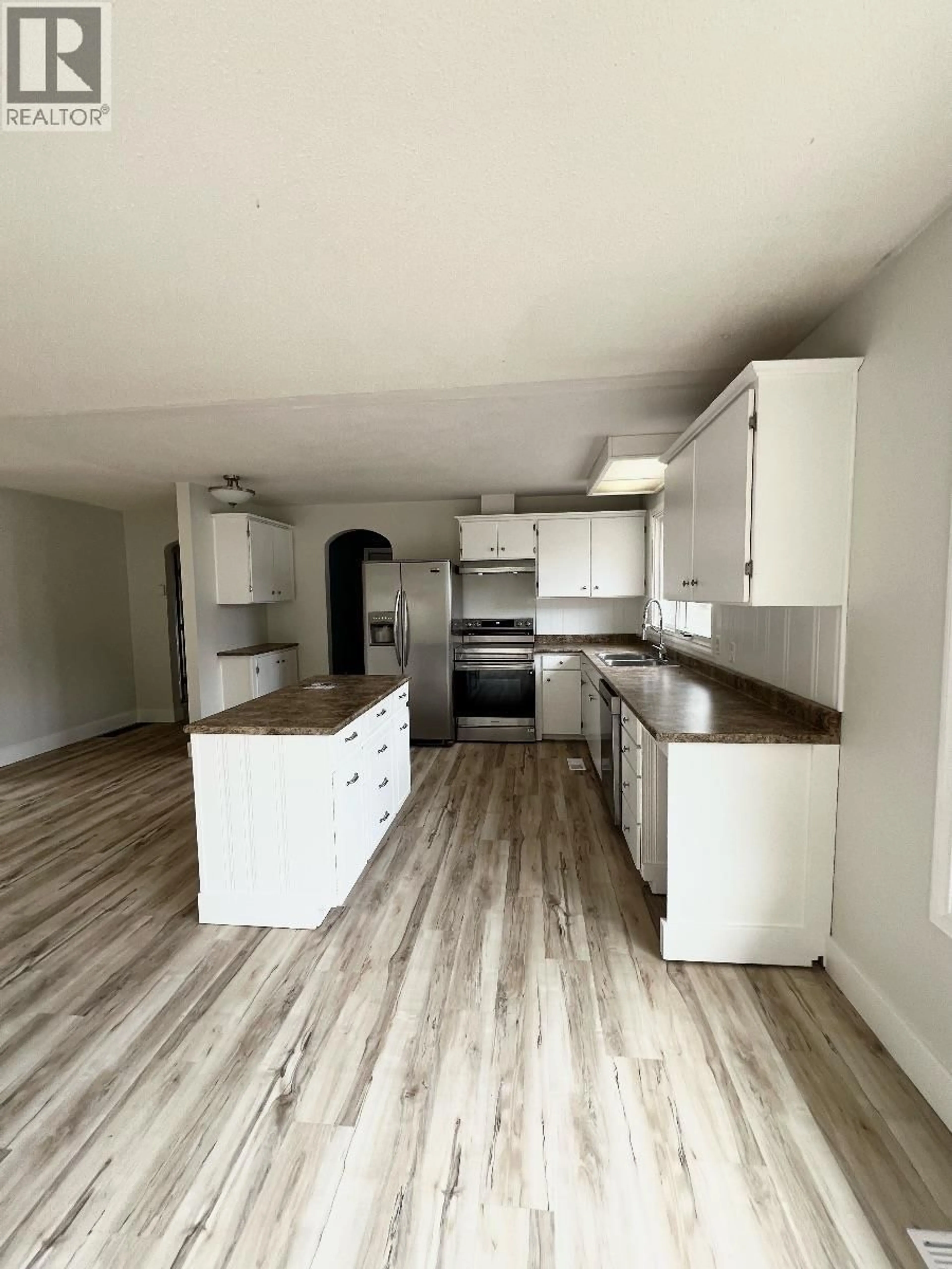 Open concept kitchen, wood/laminate floor for 1318 PINE STREET, Telkwa British Columbia V0J2X1