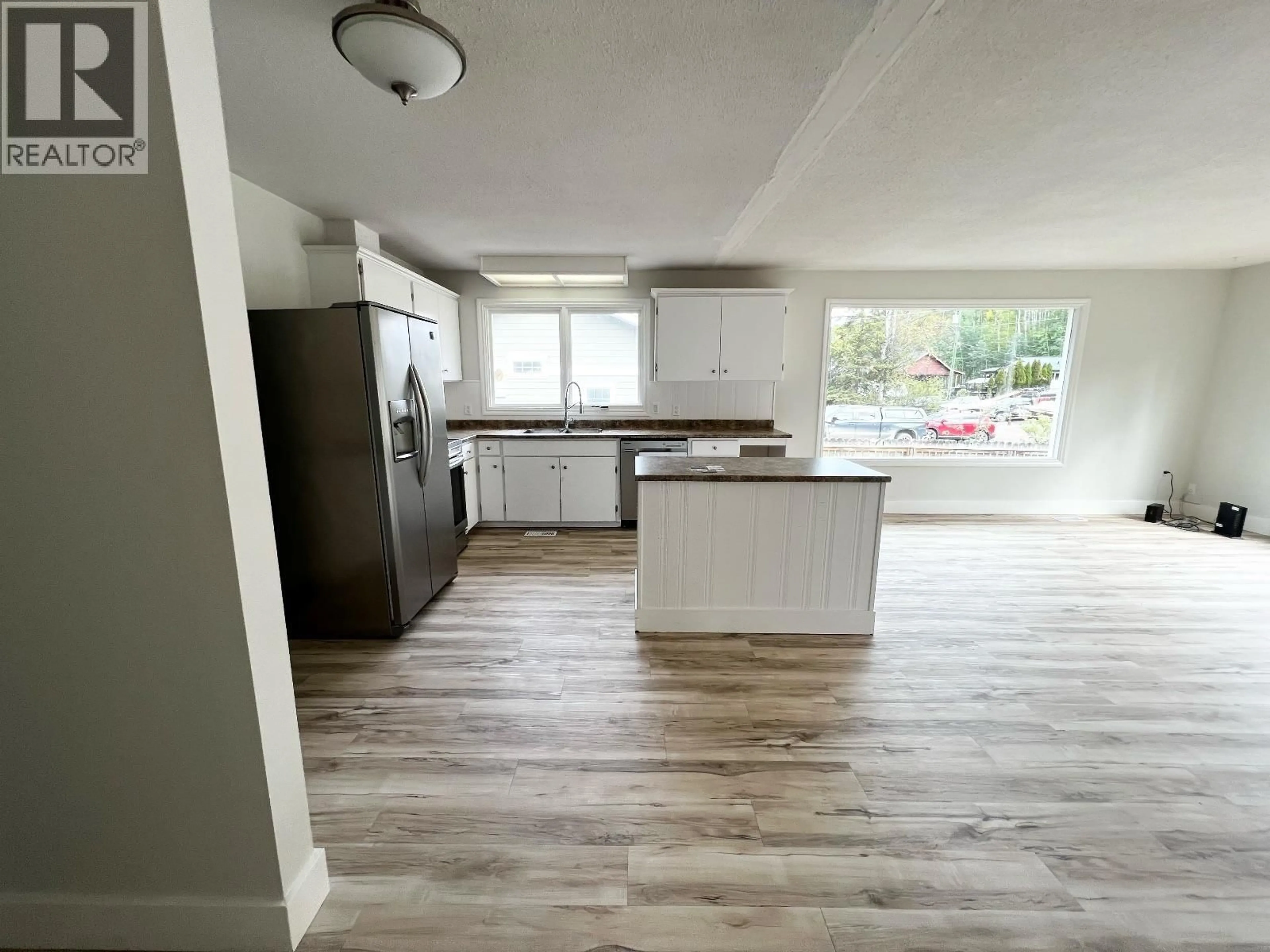 Open concept kitchen, wood/laminate floor for 1318 PINE STREET, Telkwa British Columbia V0J2X1