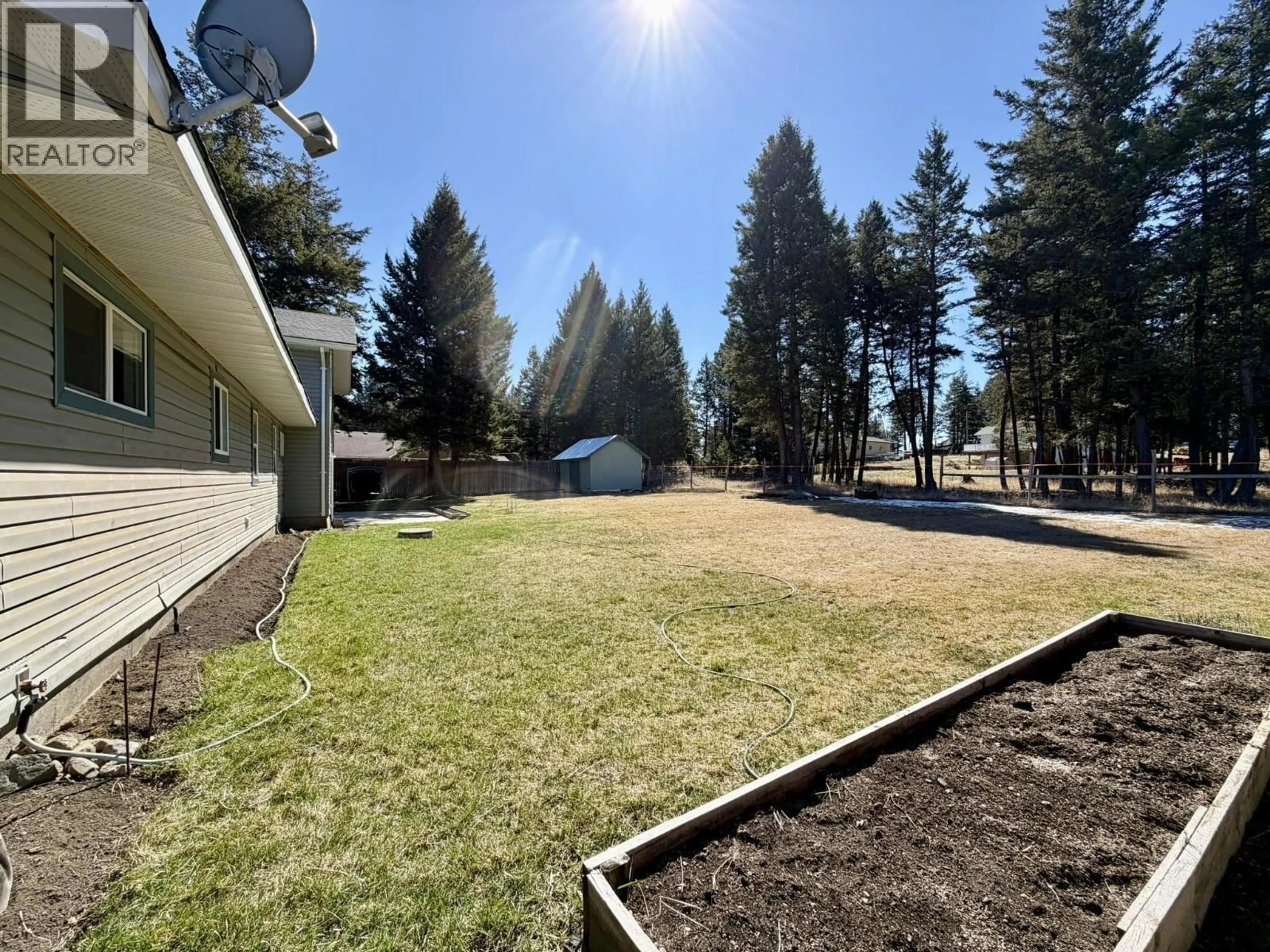 A pic from outside/outdoor area/front of a property/back of a property/a pic from drone, forest/trees view for 4994 DONSLEEQUA ROAD, 108 Mile Ranch British Columbia V0K2Z0