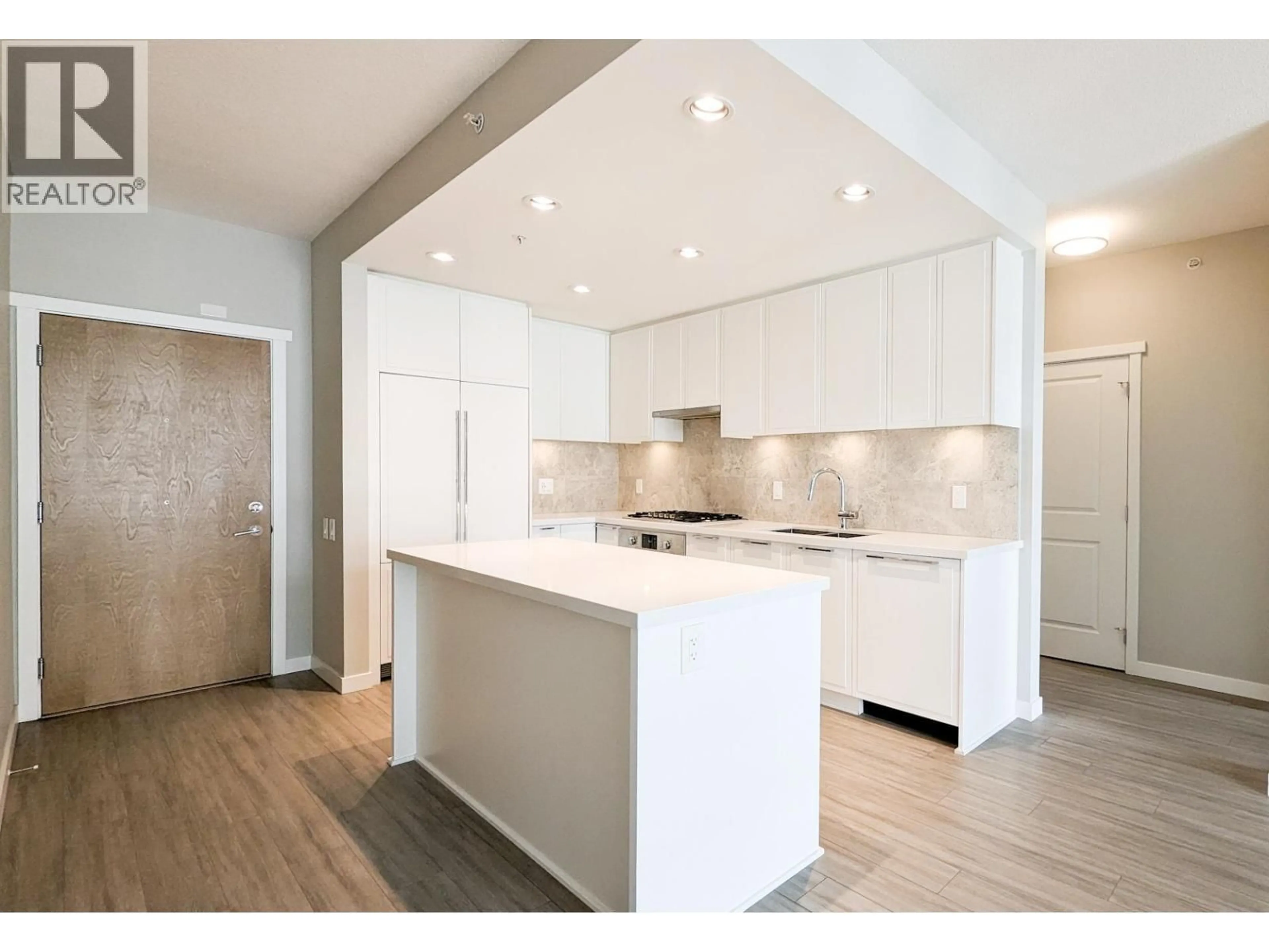 Open concept kitchen, wood/laminate floor for 402 - 3188 RIVERWALK AVENUE, Vancouver British Columbia V5S0E7