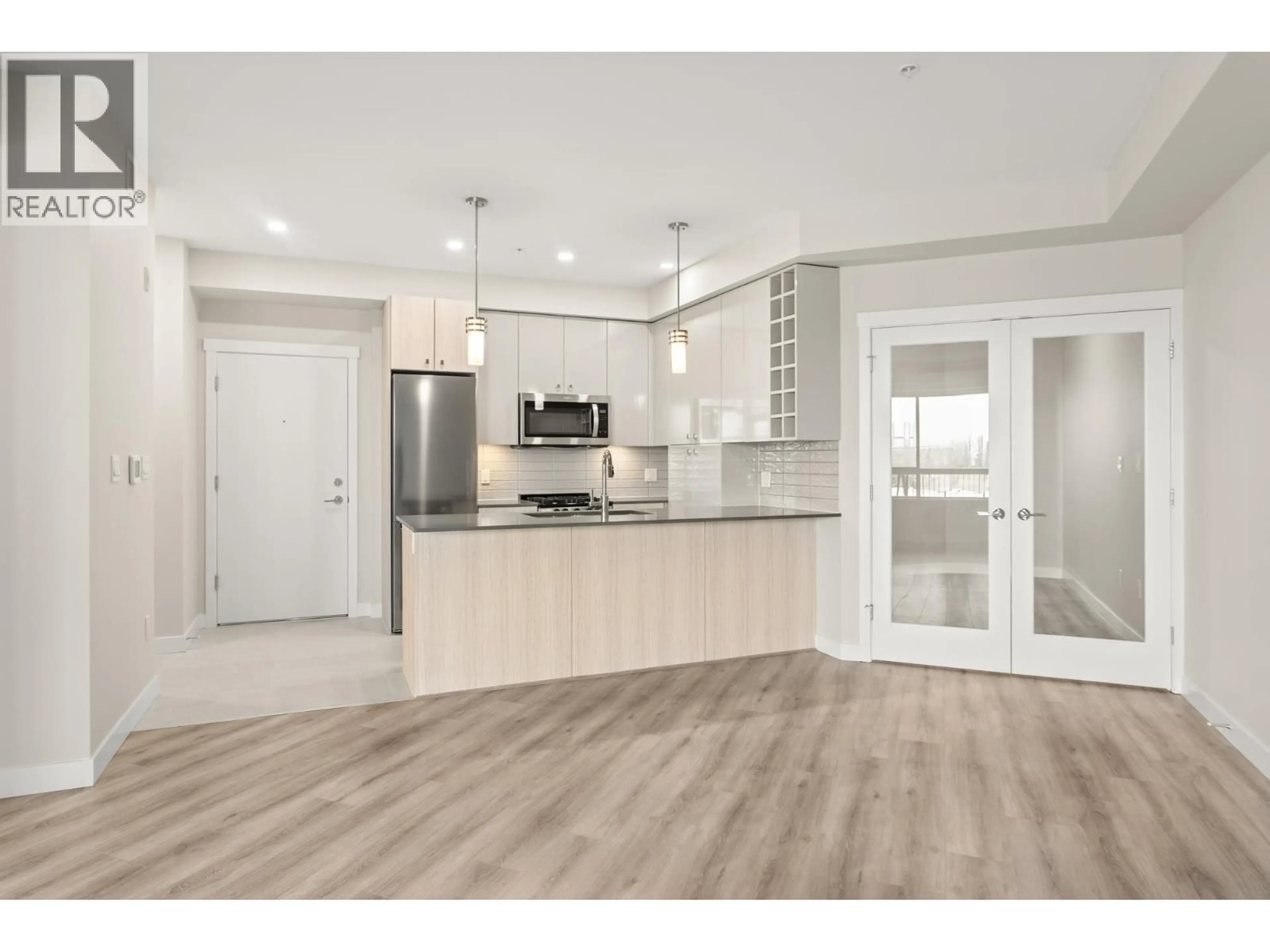 Open concept kitchen, wood/laminate floor for 425 - 23222 GILLEY ROAD, Richmond British Columbia V6V0C8