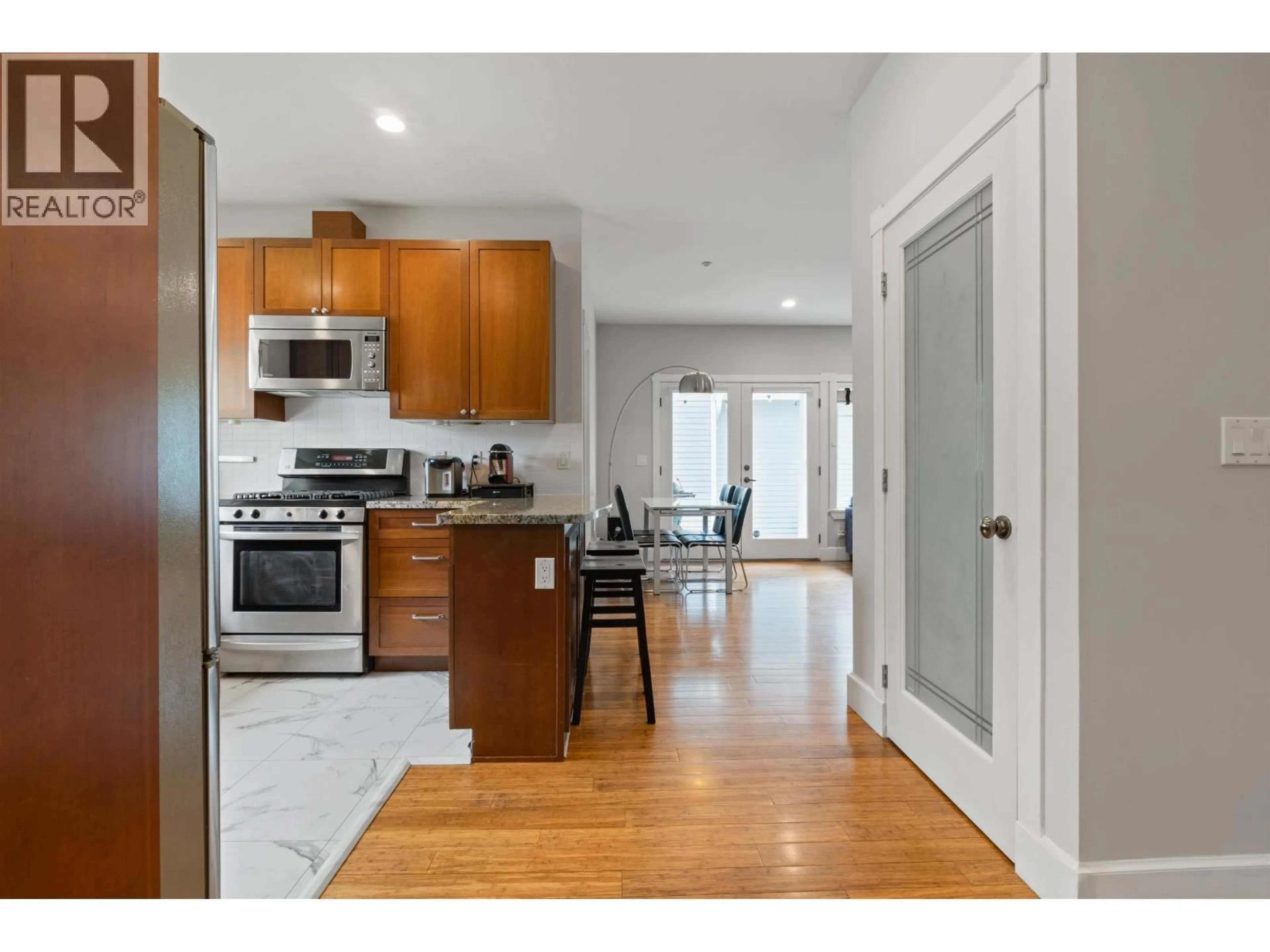 Open concept kitchen, wood/laminate floor for 4103 INVERNESS STREET, Vancouver British Columbia V5V5C5