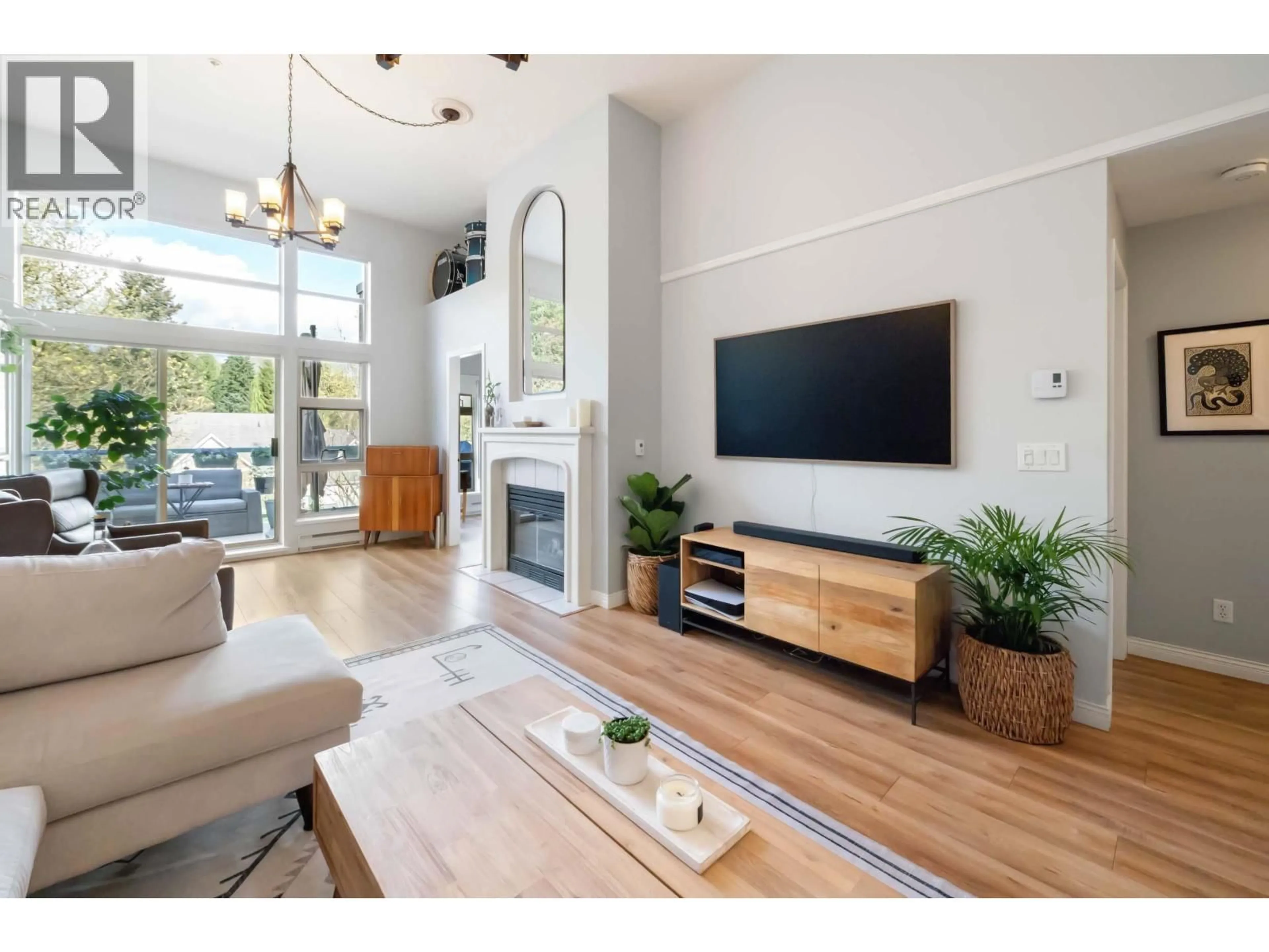 Living room with furniture, wood/laminate floor for 606 - 301 MAUDE ROAD, Port Moody British Columbia V3H5B1