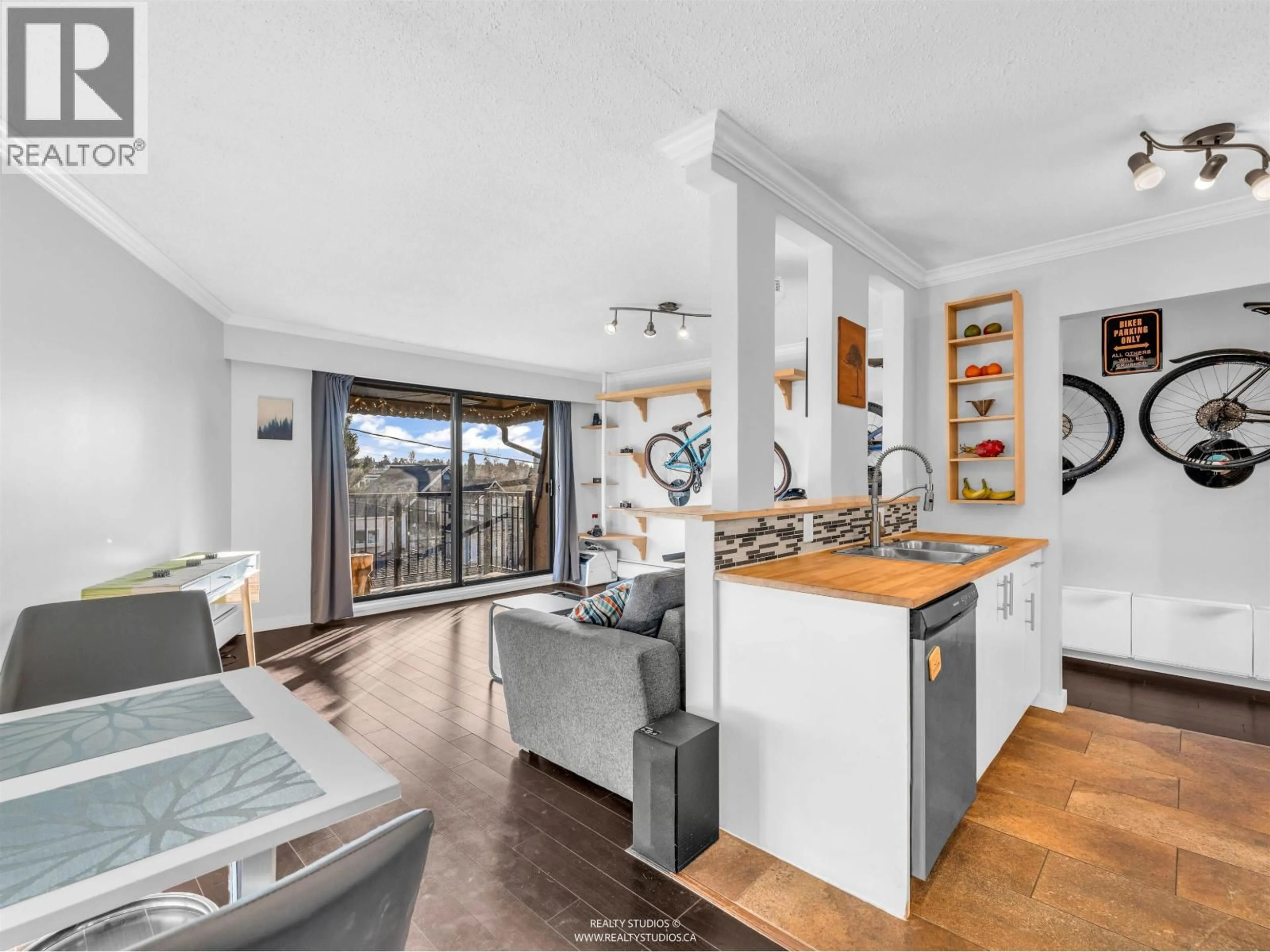 Open concept kitchen, wood/laminate floor for 306 - 2222 CAMBRIDGE STREET, Vancouver British Columbia V5L1E6