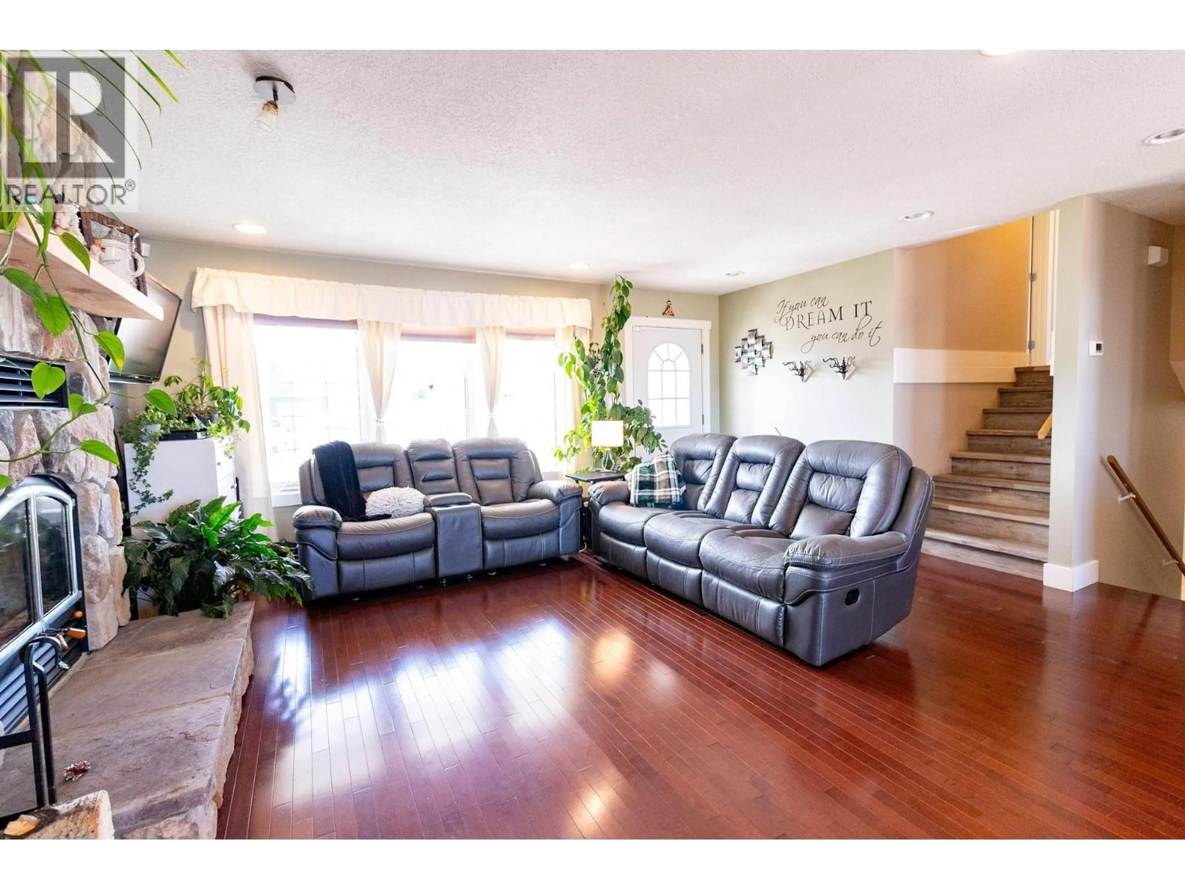 Living room with furniture, wood/laminate floor for 8720 114 AVENUE, Fort St. John British Columbia V1J0C3