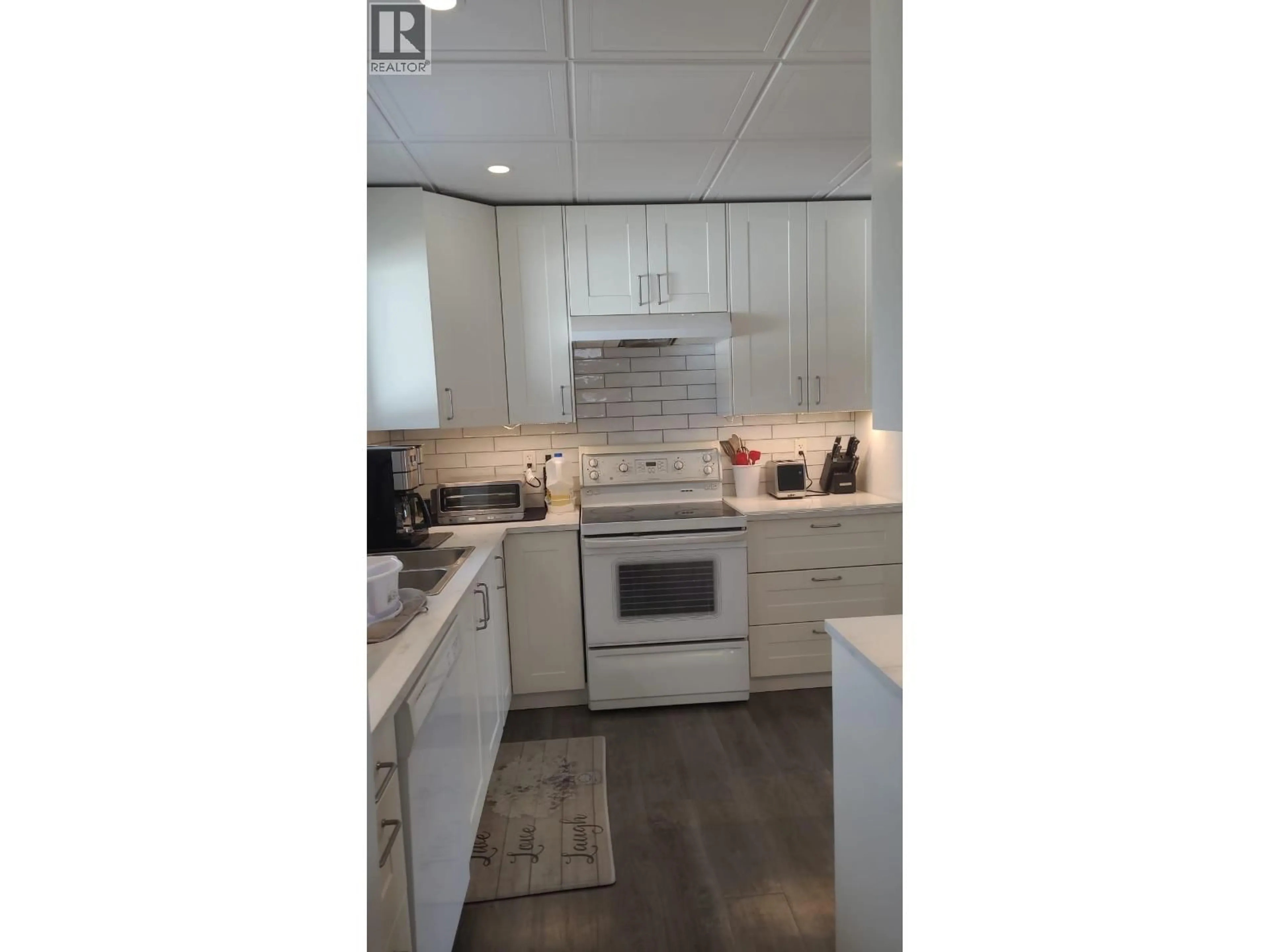 Open concept kitchen, wood/laminate floor for 2772 CECIL LAKE ROAD, Fort St. John British Columbia V0C1G0