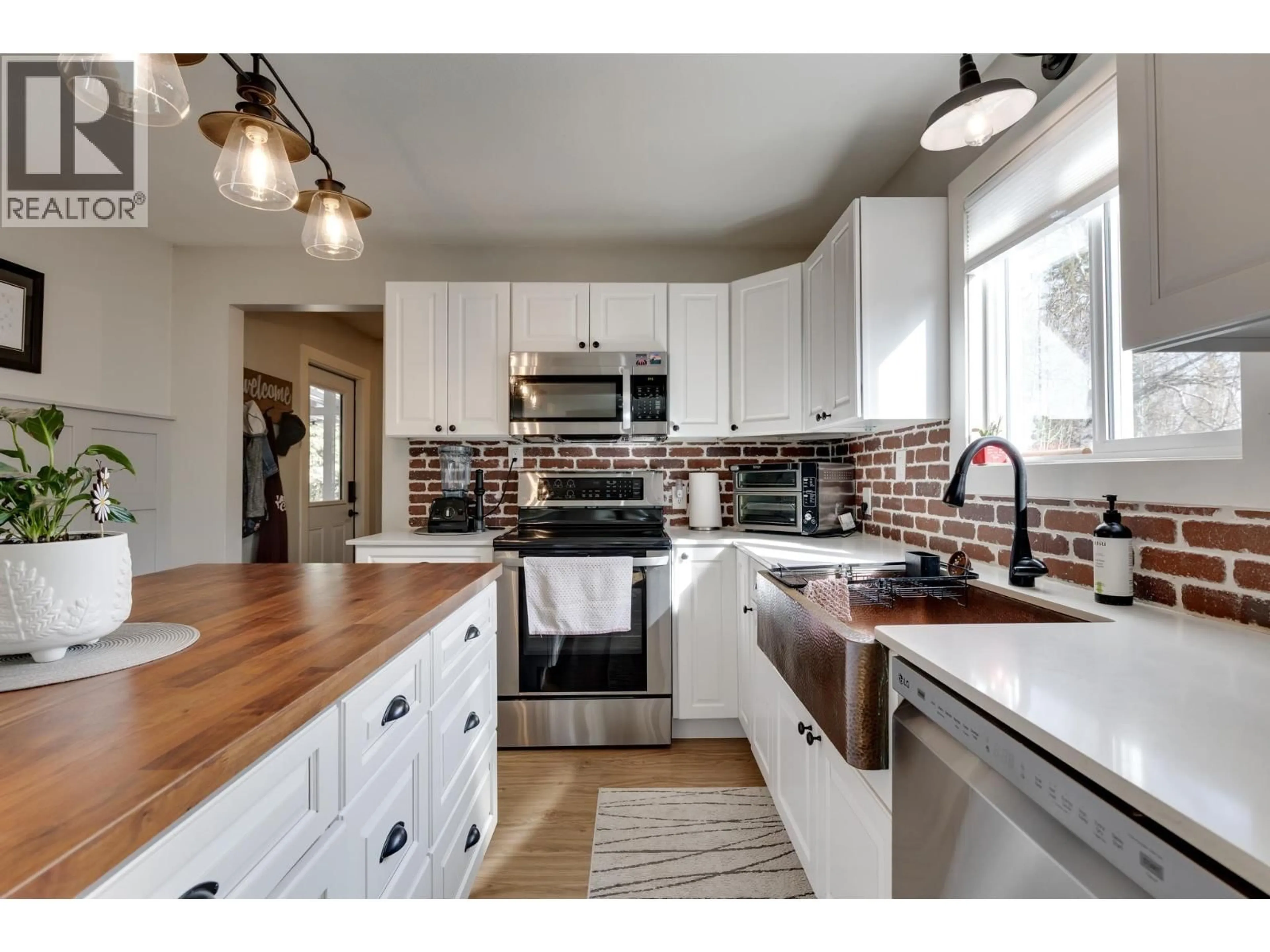 Open concept kitchen, wood/laminate floor for 8320 16 HIGHWAY, Prince George British Columbia V2N6M9