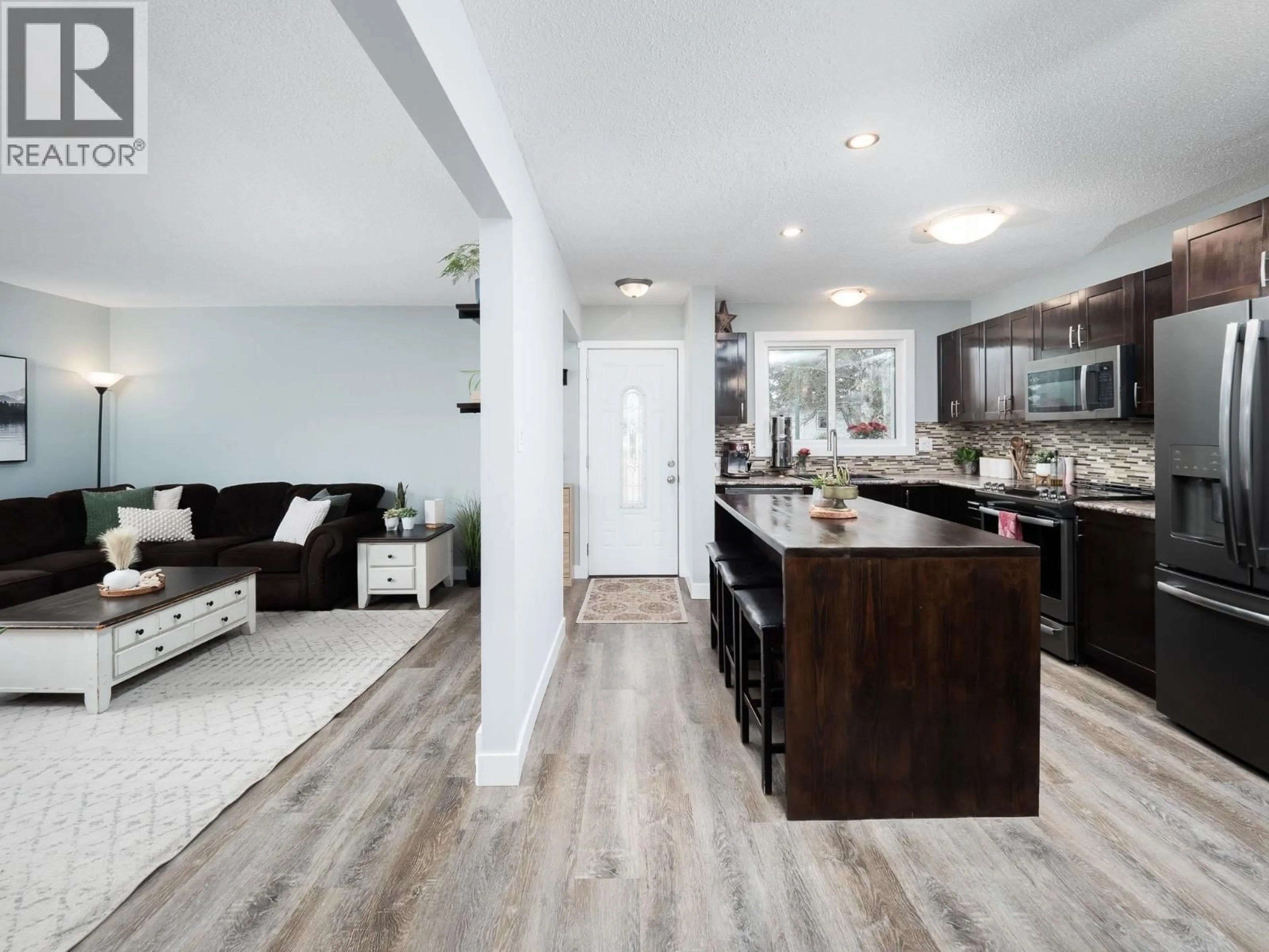Open concept kitchen, wood/laminate floor for 2293 TAPPING STREET, Prince George British Columbia V2N3B5