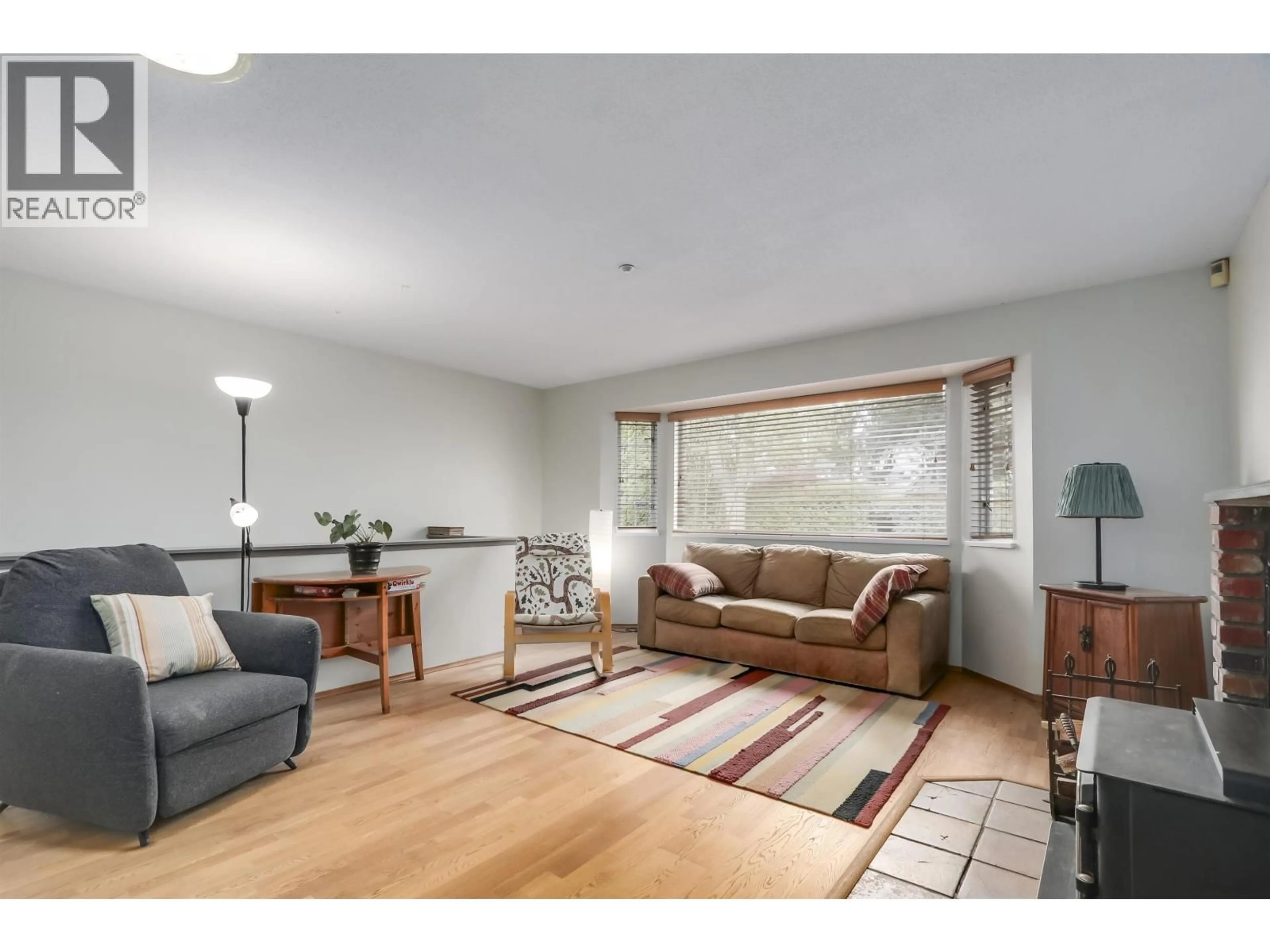 Living room with furniture, wood/laminate floor for 229 22ND STREET, North Vancouver British Columbia V7M2A2