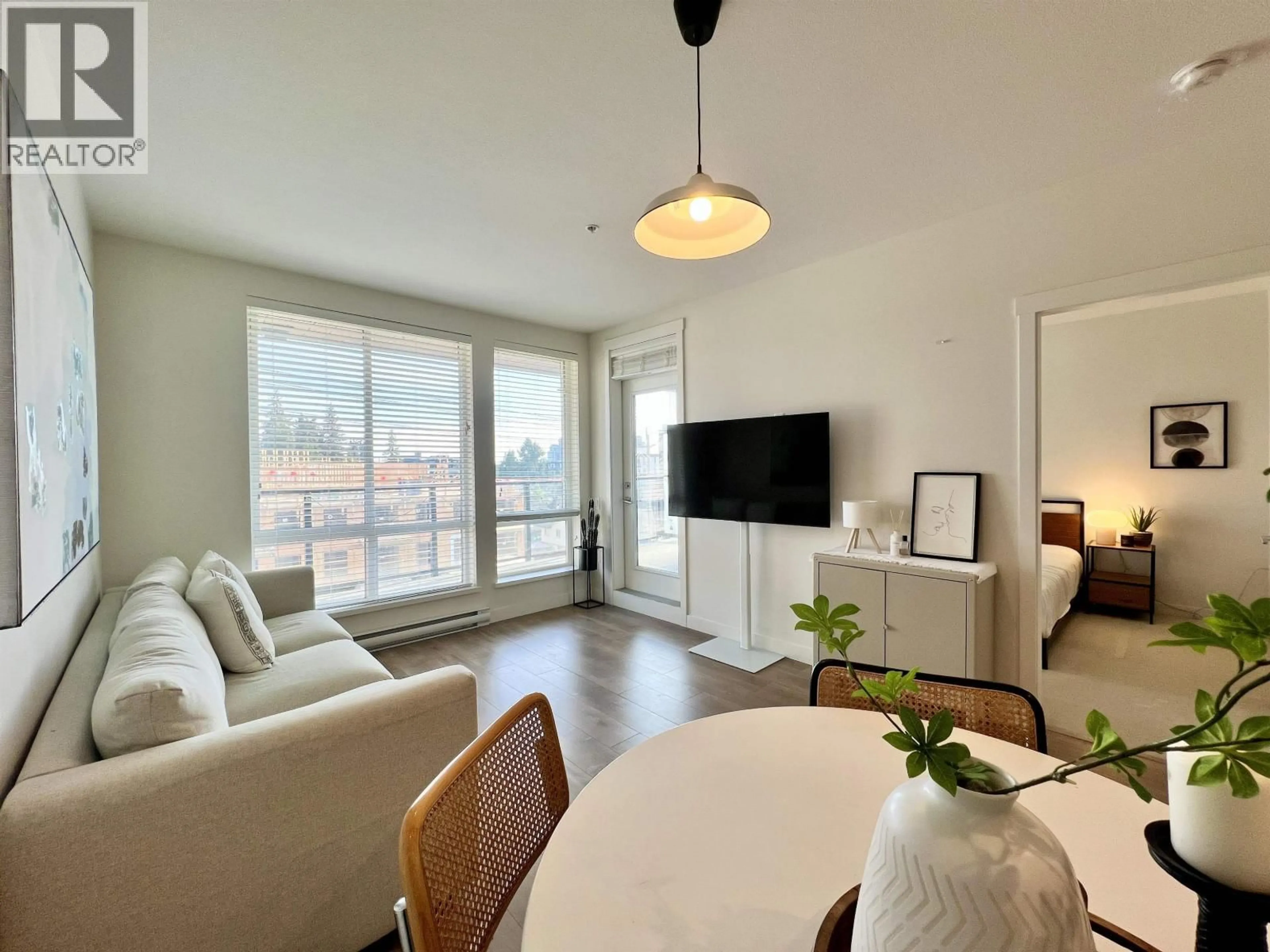 Living room with furniture, wood/laminate floor for 408 - 707 COMO LAKE AVENUE, Coquitlam British Columbia V3J0J5