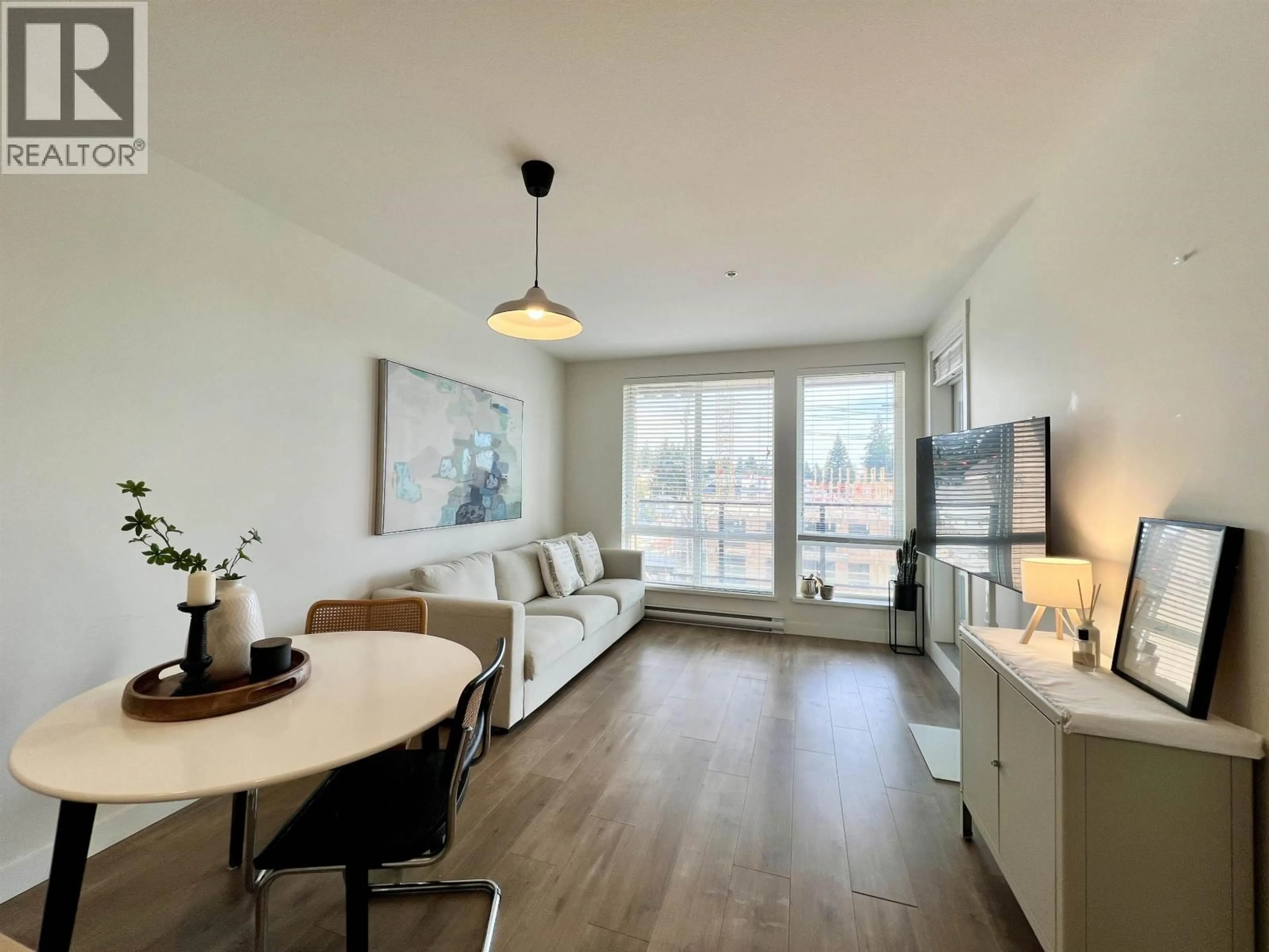 Living room with furniture, wood/laminate floor for 408 - 707 COMO LAKE AVENUE, Coquitlam British Columbia V3J0J5