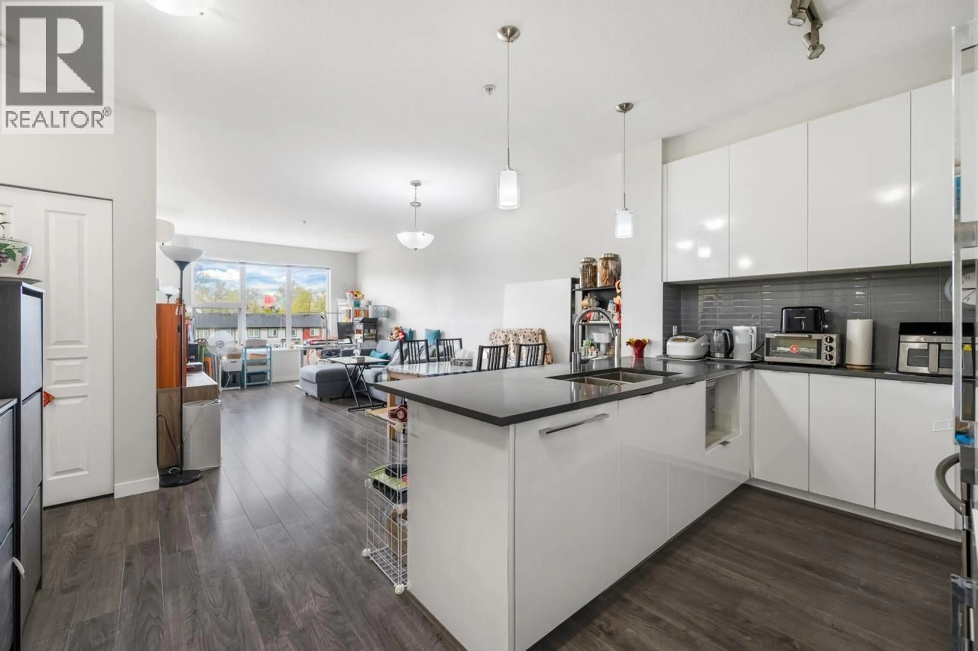 Open concept kitchen, wood/laminate floor for 320 - 9311 ALEXANDRA ROAD, Richmond British Columbia V6X0L8