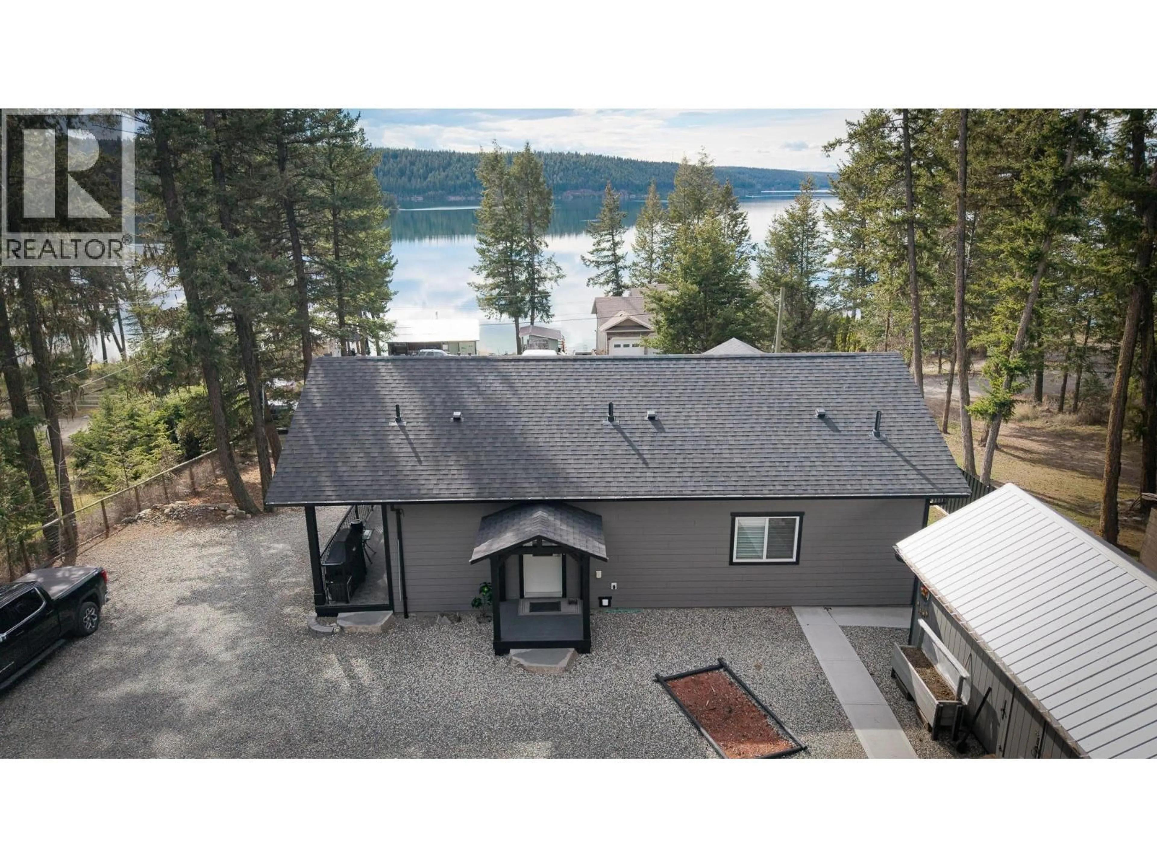 A pic from outside/outdoor area/front of a property/back of a property/a pic from drone, water/lake/river/ocean view for 3779 EMERALD CRESCENT, Lac La Hache British Columbia V0K1T1