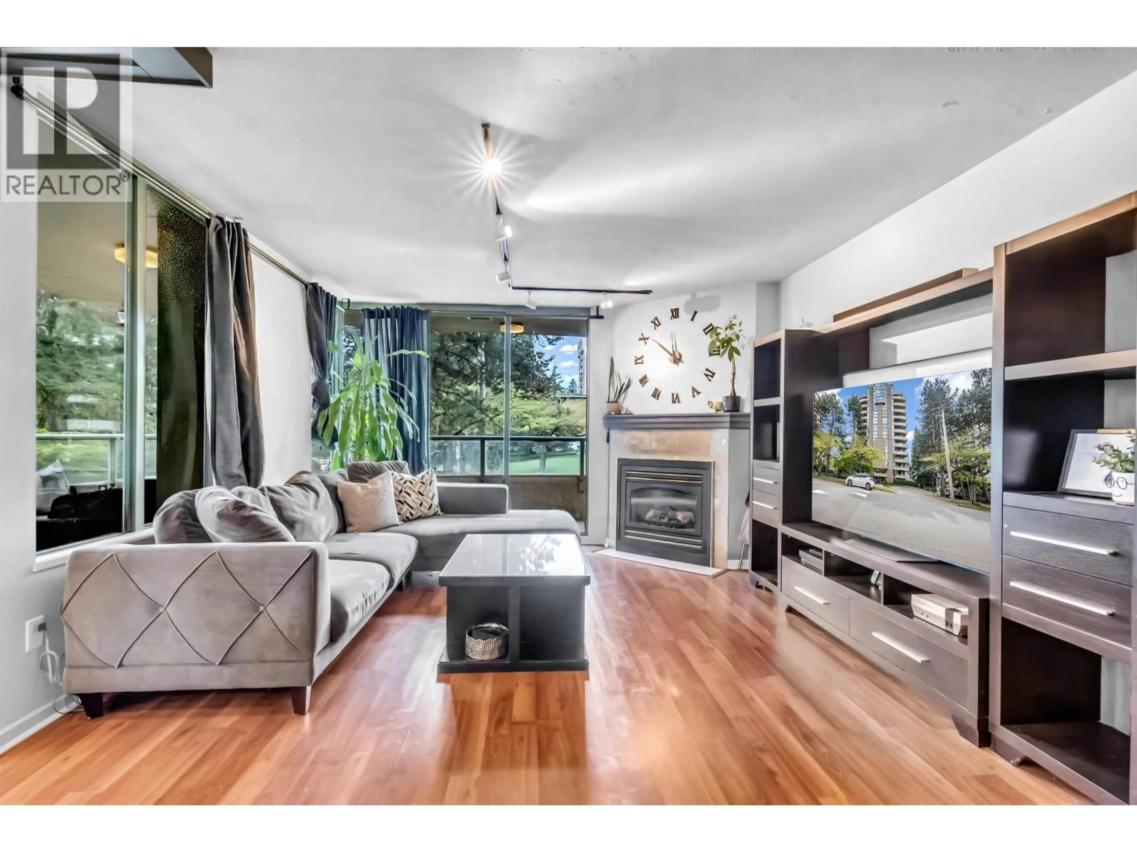 Living room with furniture, wood/laminate floor for 220 - 7288 ACORN AVENUE, Burnaby British Columbia V5E4H6