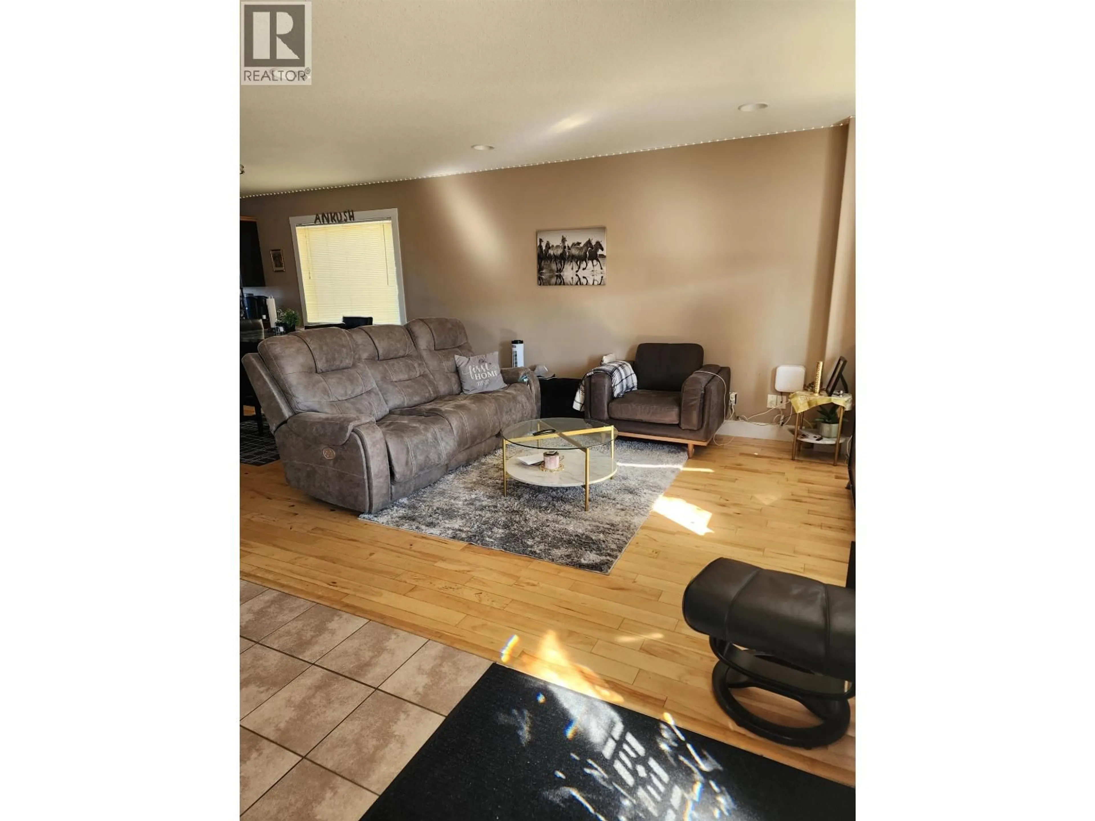 Living room with furniture, wood/laminate floor for 8314 87 STREET, Fort St. John British Columbia V1J3M7