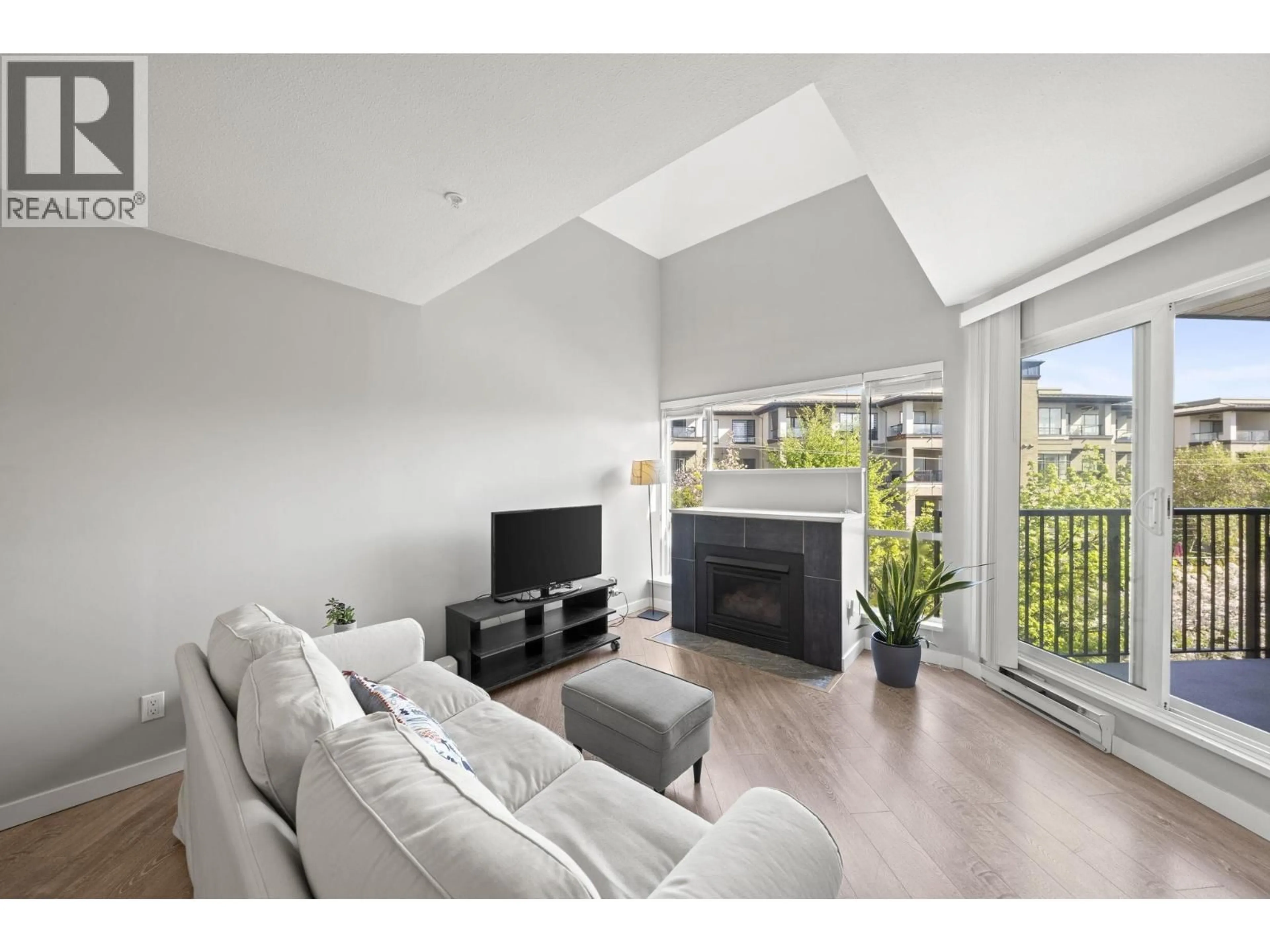 Living room with furniture, wood/laminate floor for 303 - 2429 HAWTHORNE AVENUE, Port Coquitlam British Columbia V3C6G6