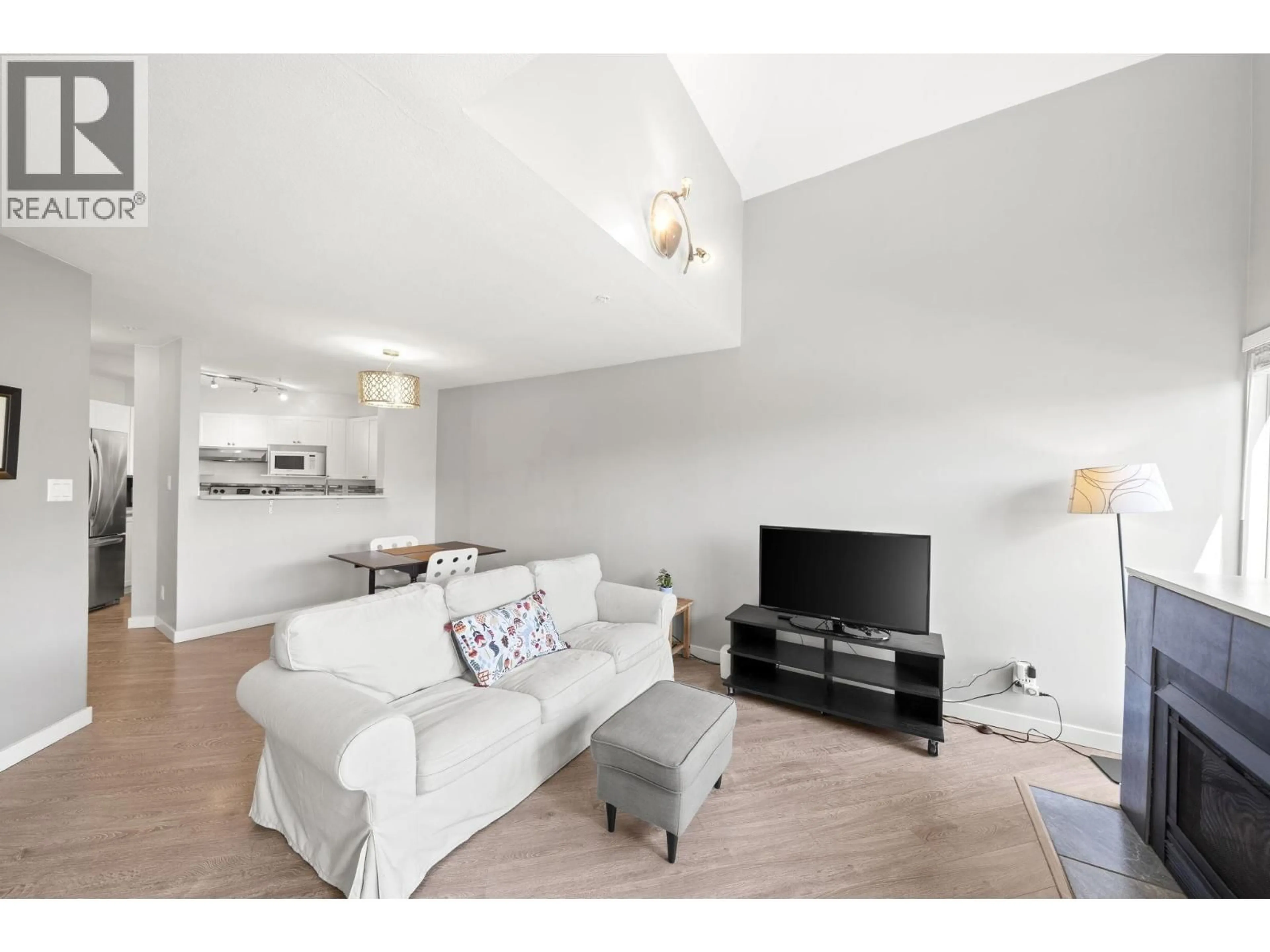 Living room with furniture, wood/laminate floor for 303 - 2429 HAWTHORNE AVENUE, Port Coquitlam British Columbia V3C6G6