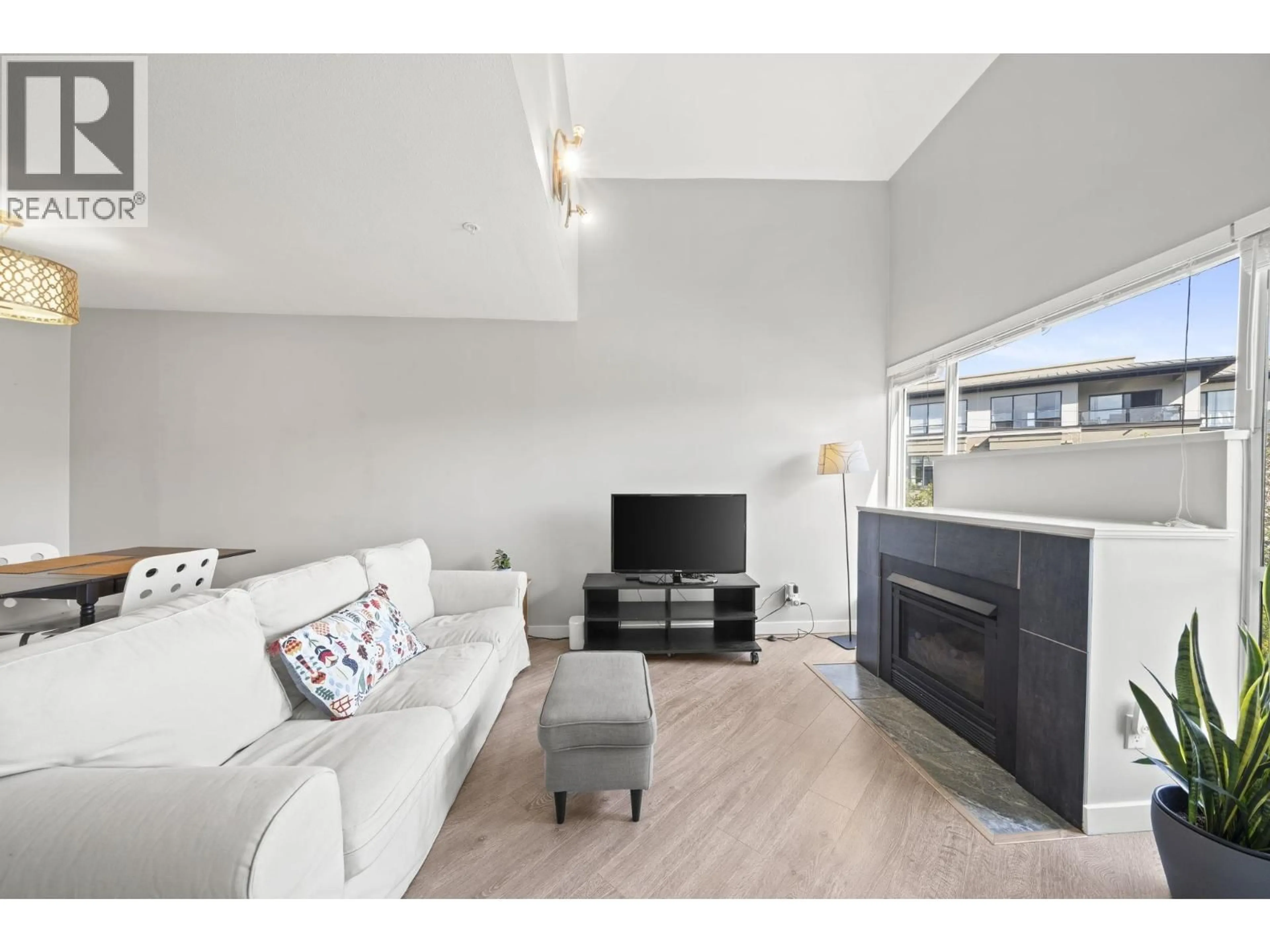 Living room with furniture, wood/laminate floor for 303 - 2429 HAWTHORNE AVENUE, Port Coquitlam British Columbia V3C6G6