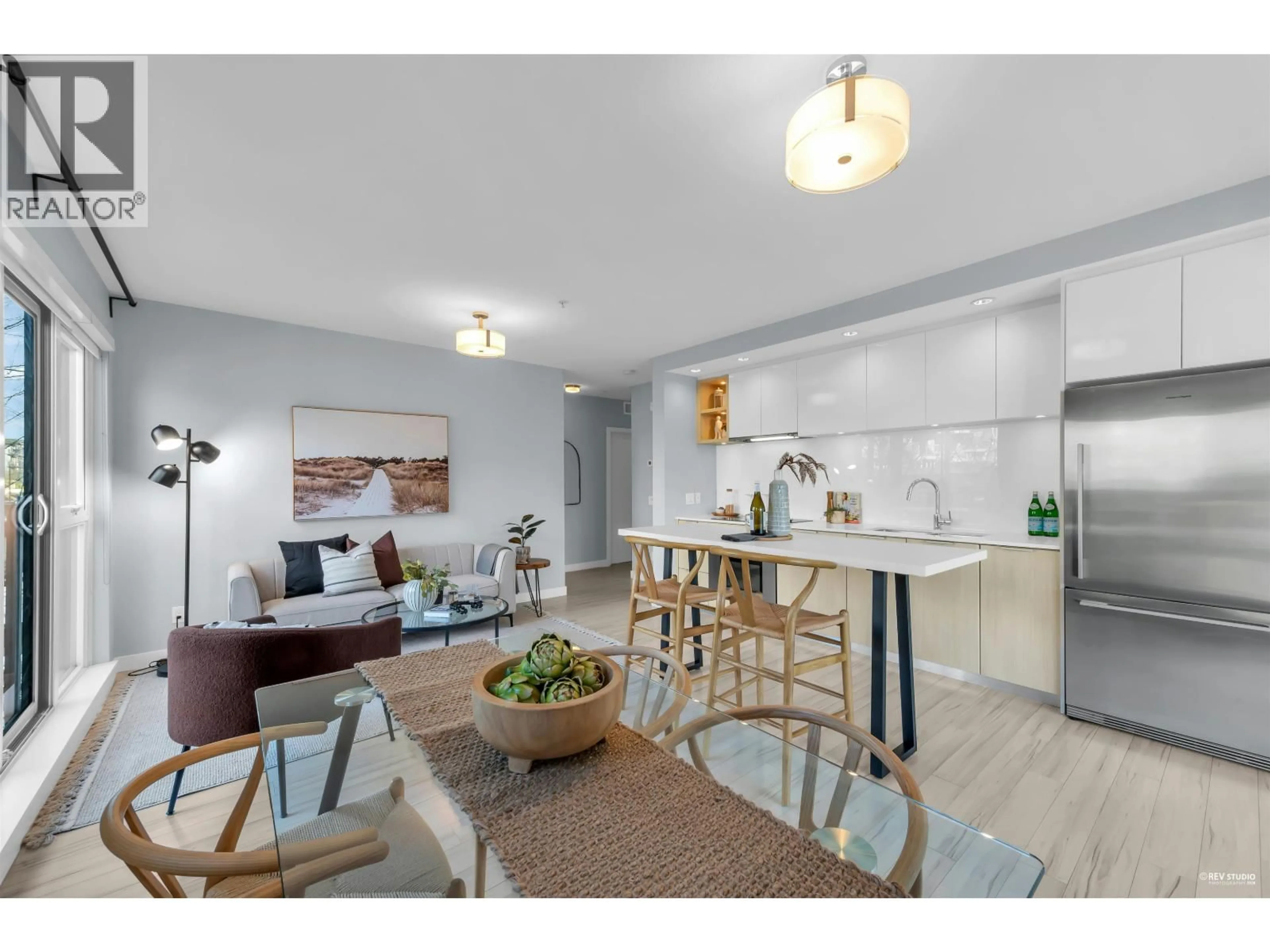 Open concept kitchen, wood/laminate floor for 207 - 111 3RD STREET, North Vancouver British Columbia V7L0C6