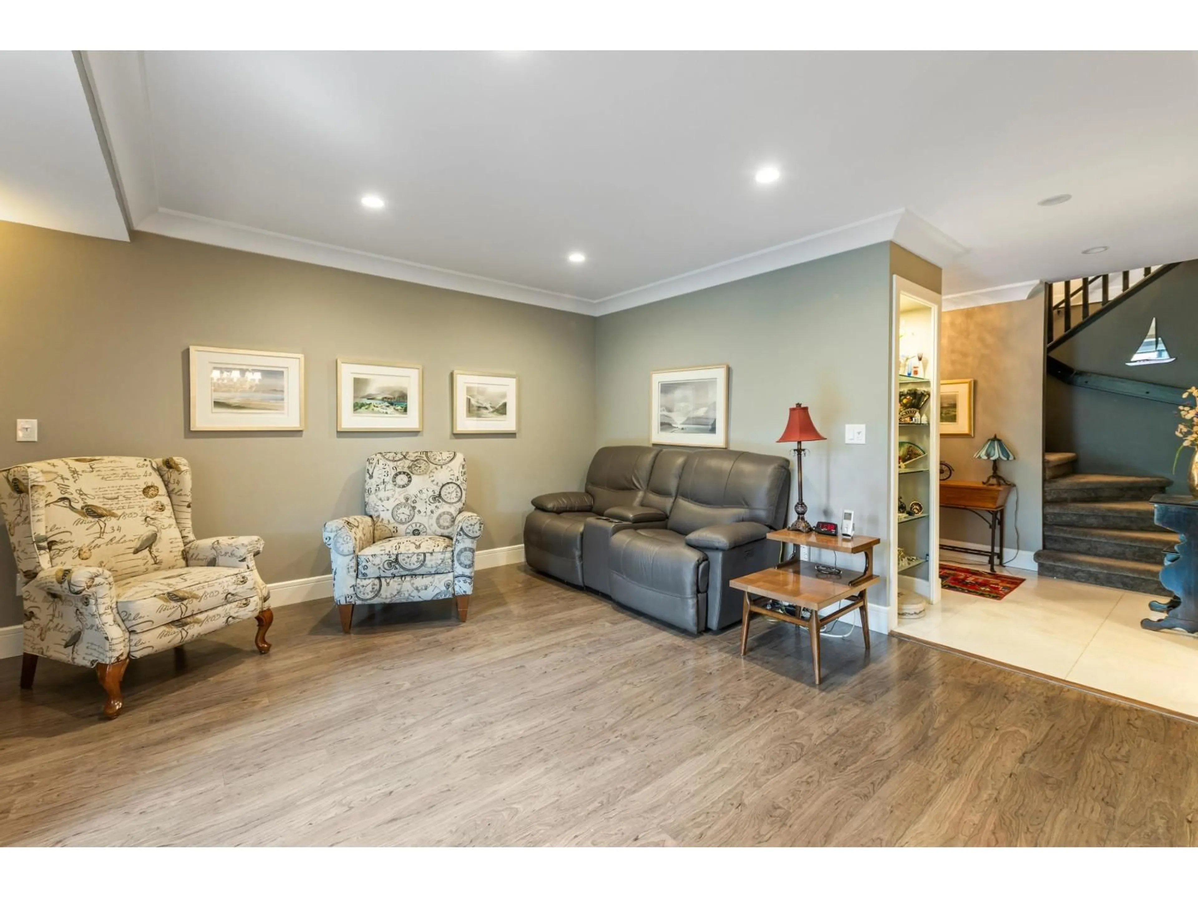 Living room with furniture, wood/laminate floor for 103 - 12757 16 AVENUE, Surrey British Columbia V4A1N2