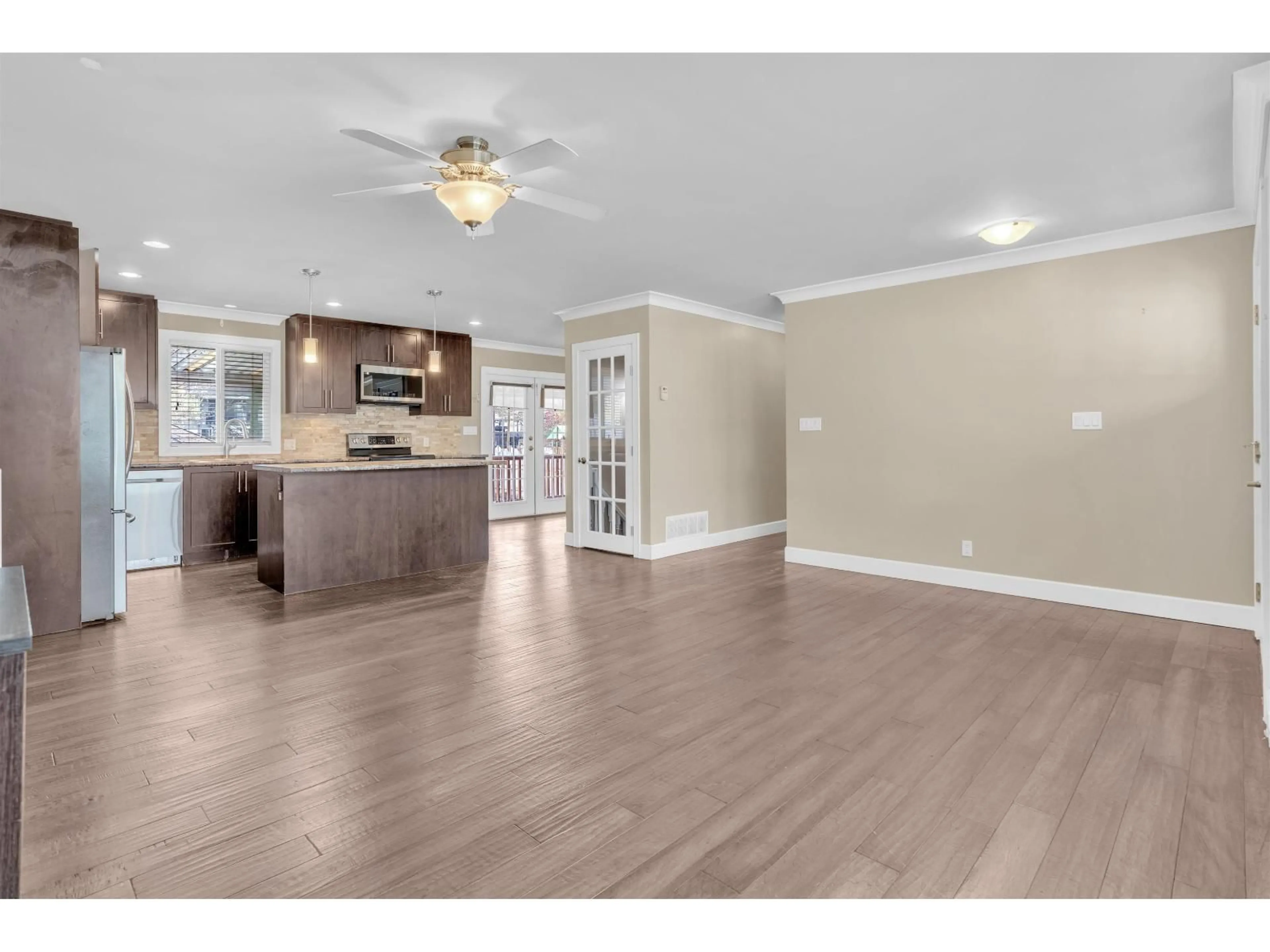 Open concept kitchen, wood/laminate floor for 14682 111 AVENUE, Surrey British Columbia V3R2C4