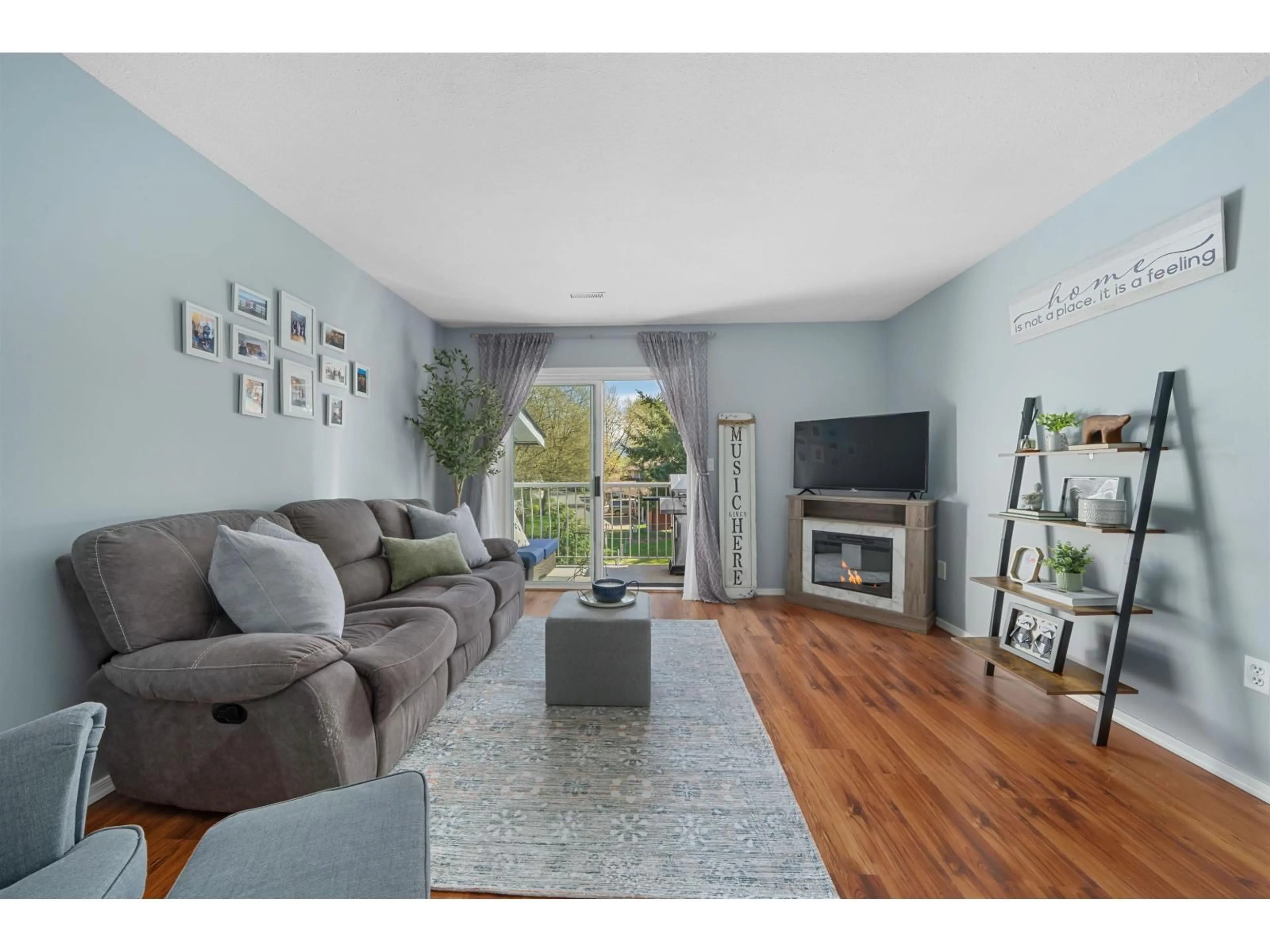 Living room with furniture, wood/laminate floor for 30 - 7715 LUCKAKUCK PLACE, Chilliwack British Columbia V2R3N6