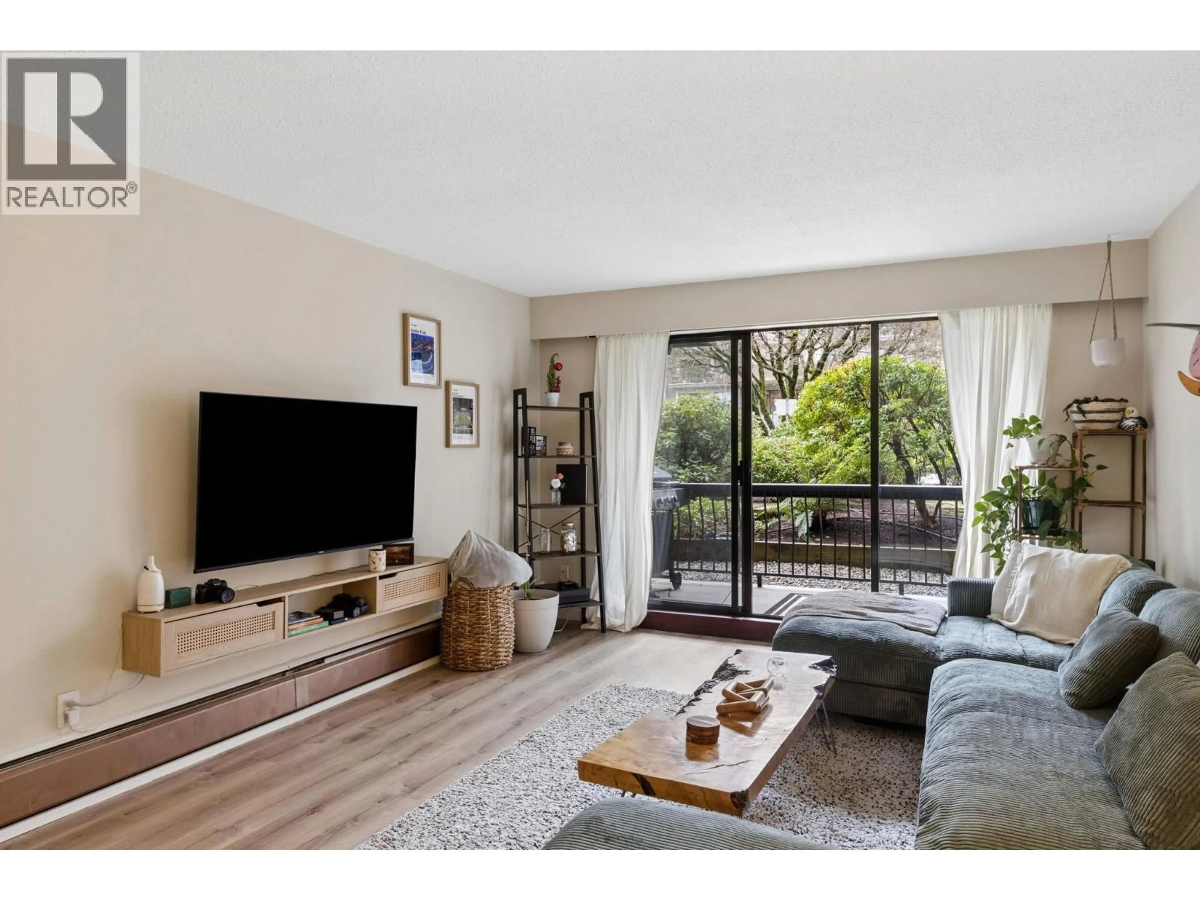 Living room with furniture, wood/laminate floor for 101 - 175 5TH STREET, North Vancouver British Columbia V7L1L3