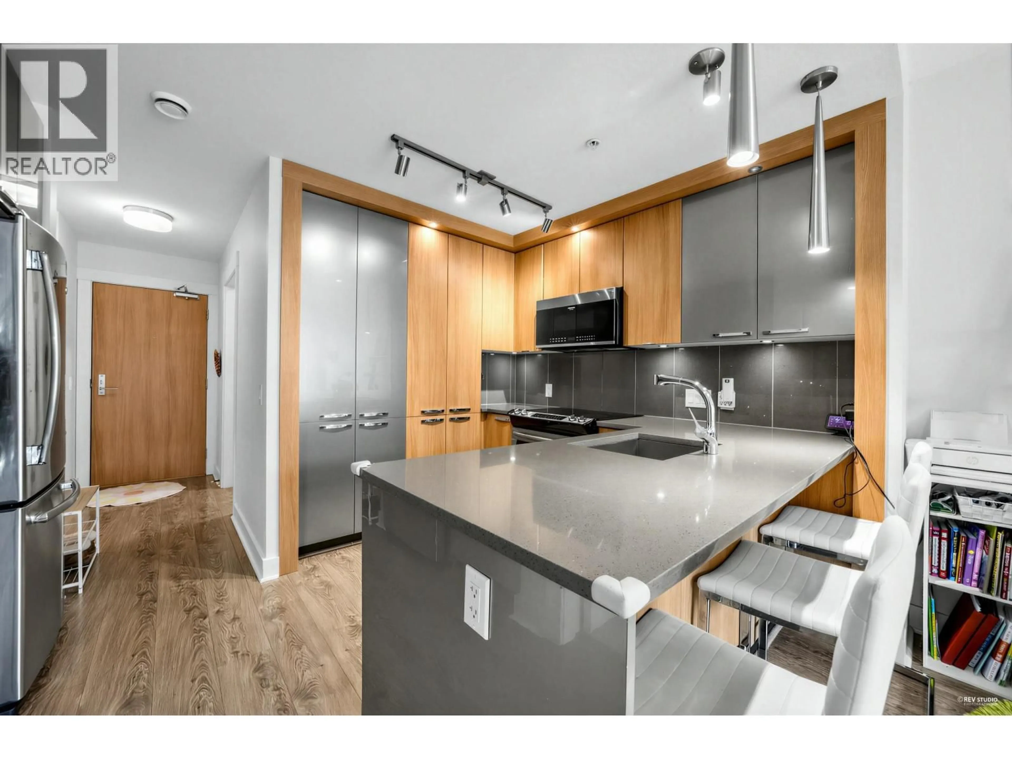 Open concept kitchen, wood/laminate floor for 307 - 733 14TH STREET, North Vancouver British Columbia V7M0C6