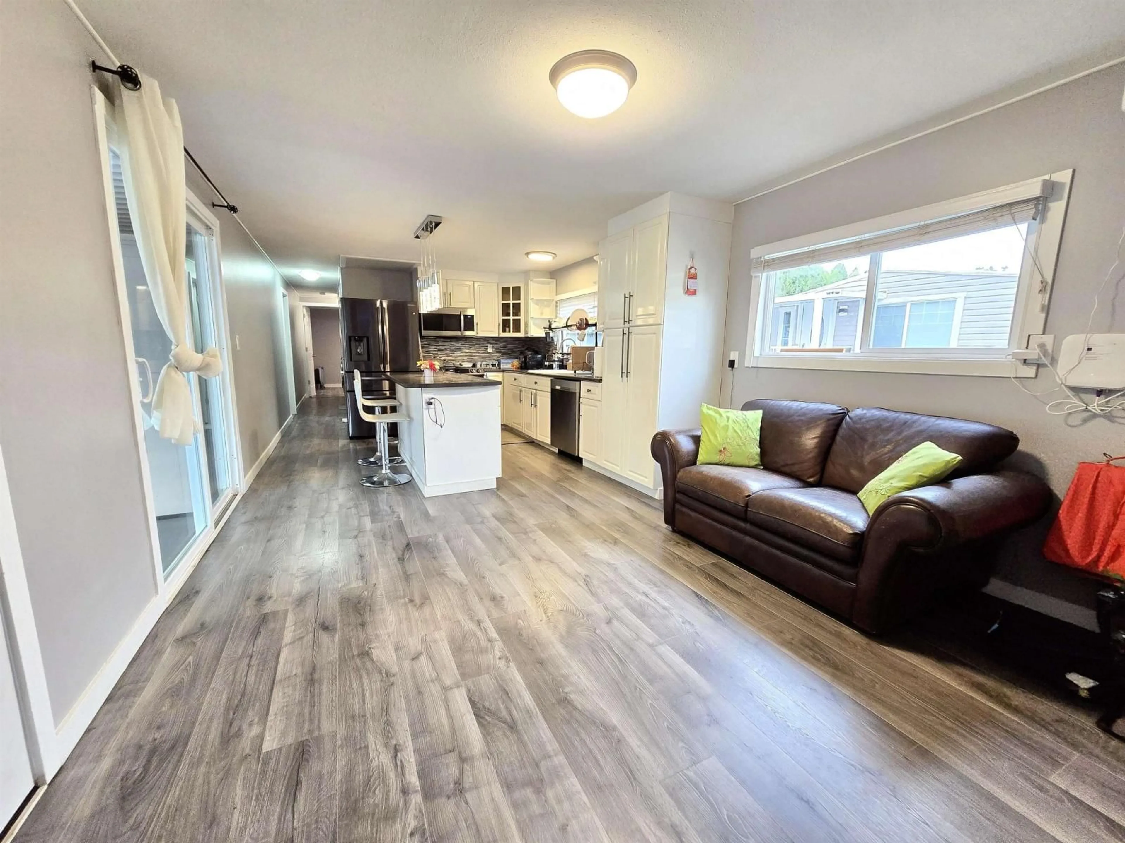 Open concept kitchen, wood/laminate floor for 56 - 8220 KING GEORGE BOULEVARD, Surrey British Columbia V3W6E1