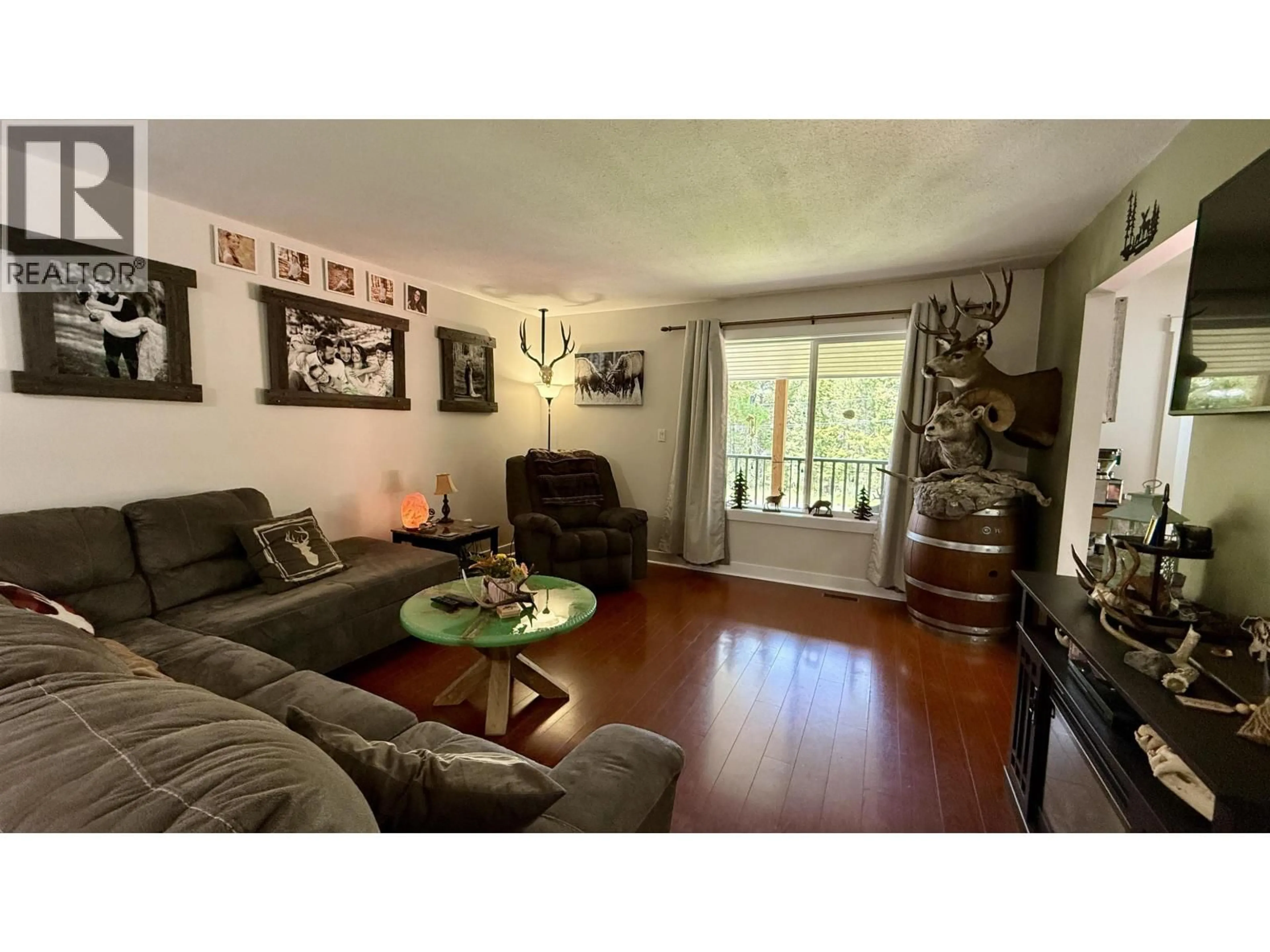 Living room with furniture, wood/laminate floor for 4755 ANZEEON ROAD, 108 Mile Ranch British Columbia V0K2Z0