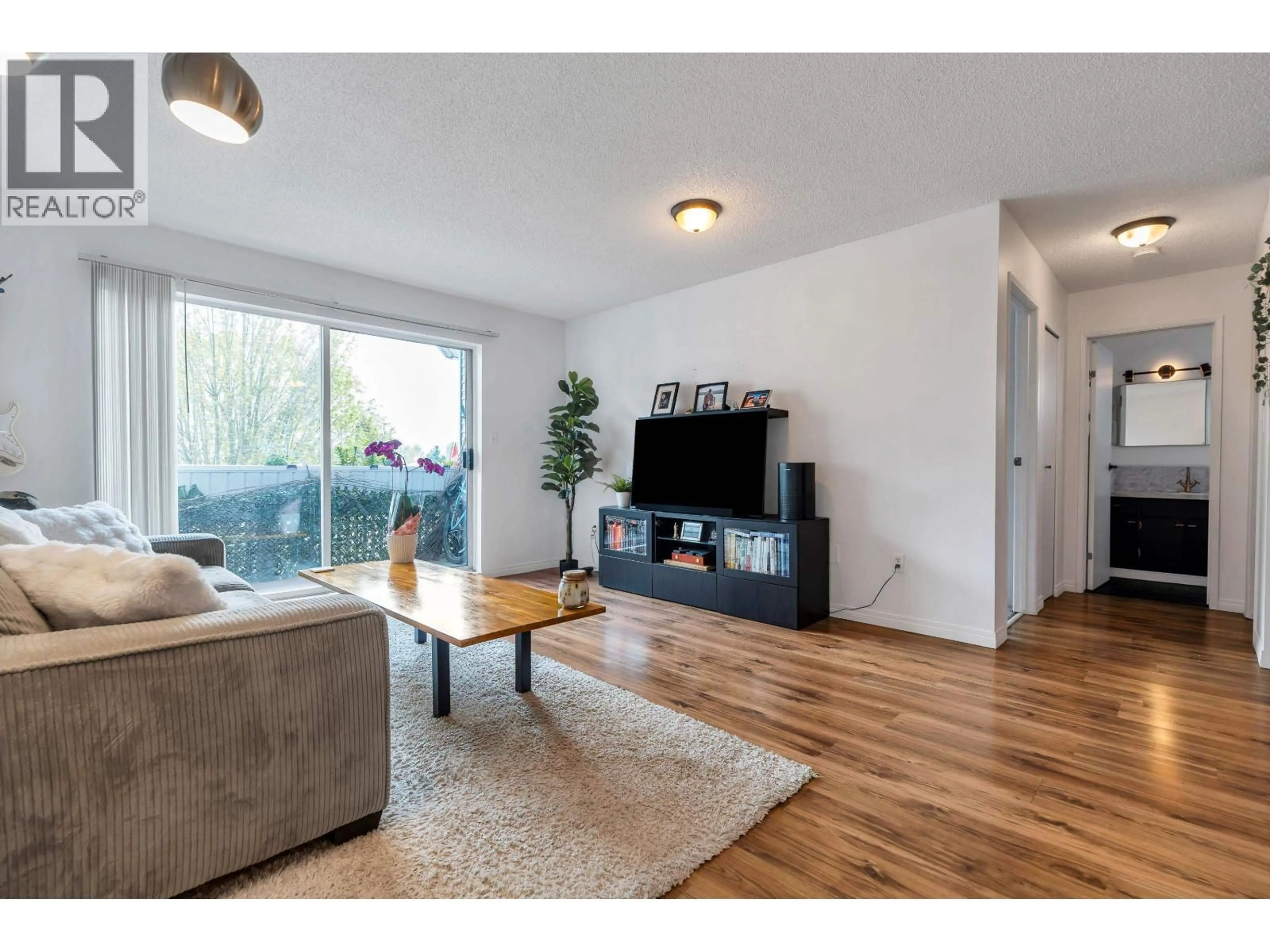 Living room with furniture, wood/laminate floor for 311 - 2055 SUFFOLK AVENUE, Port Coquitlam British Columbia V3B1H4