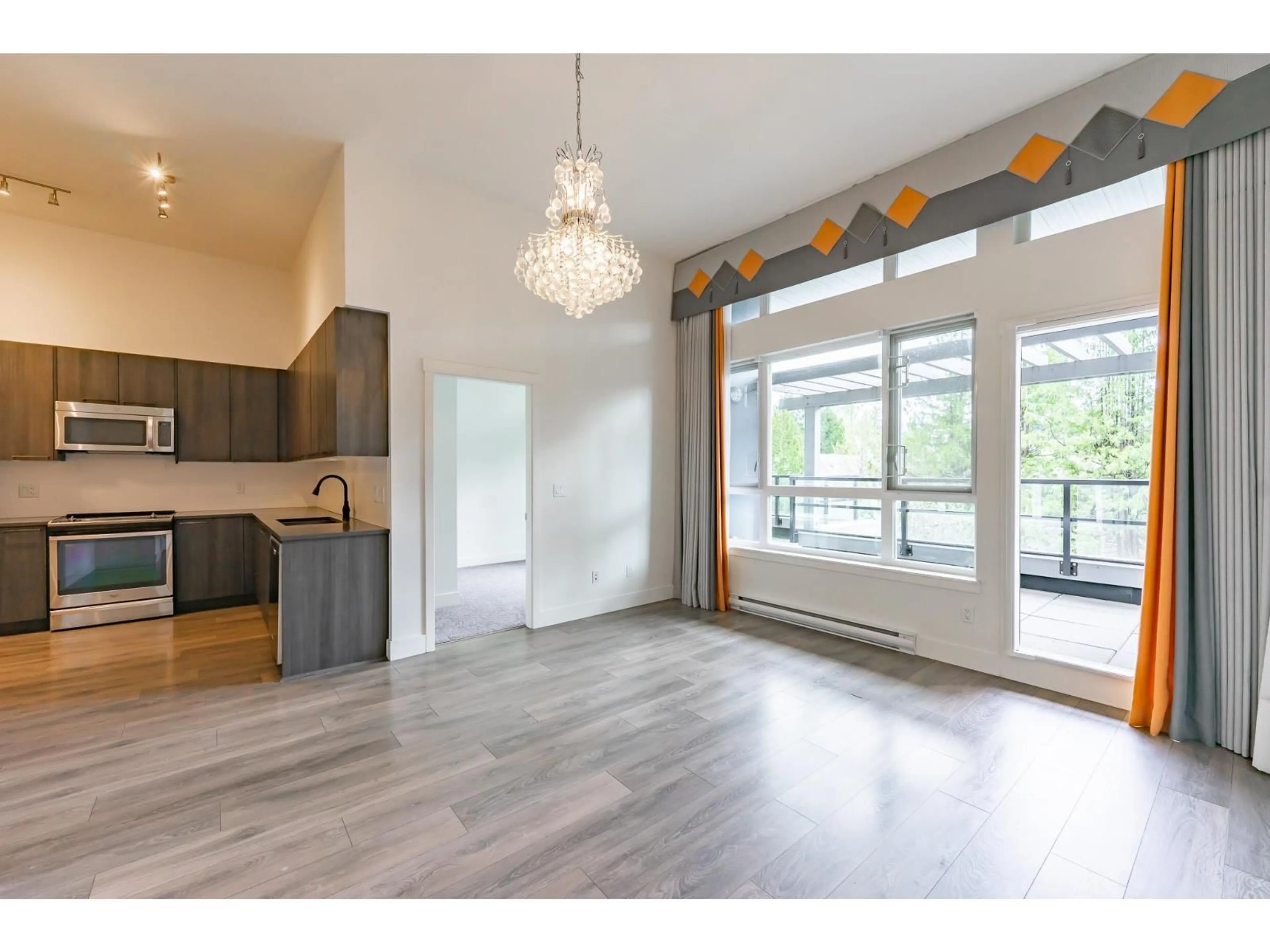 Open concept kitchen, wood/laminate floor for 405 - 15628 104 AVENUE, Surrey British Columbia V4N2J3