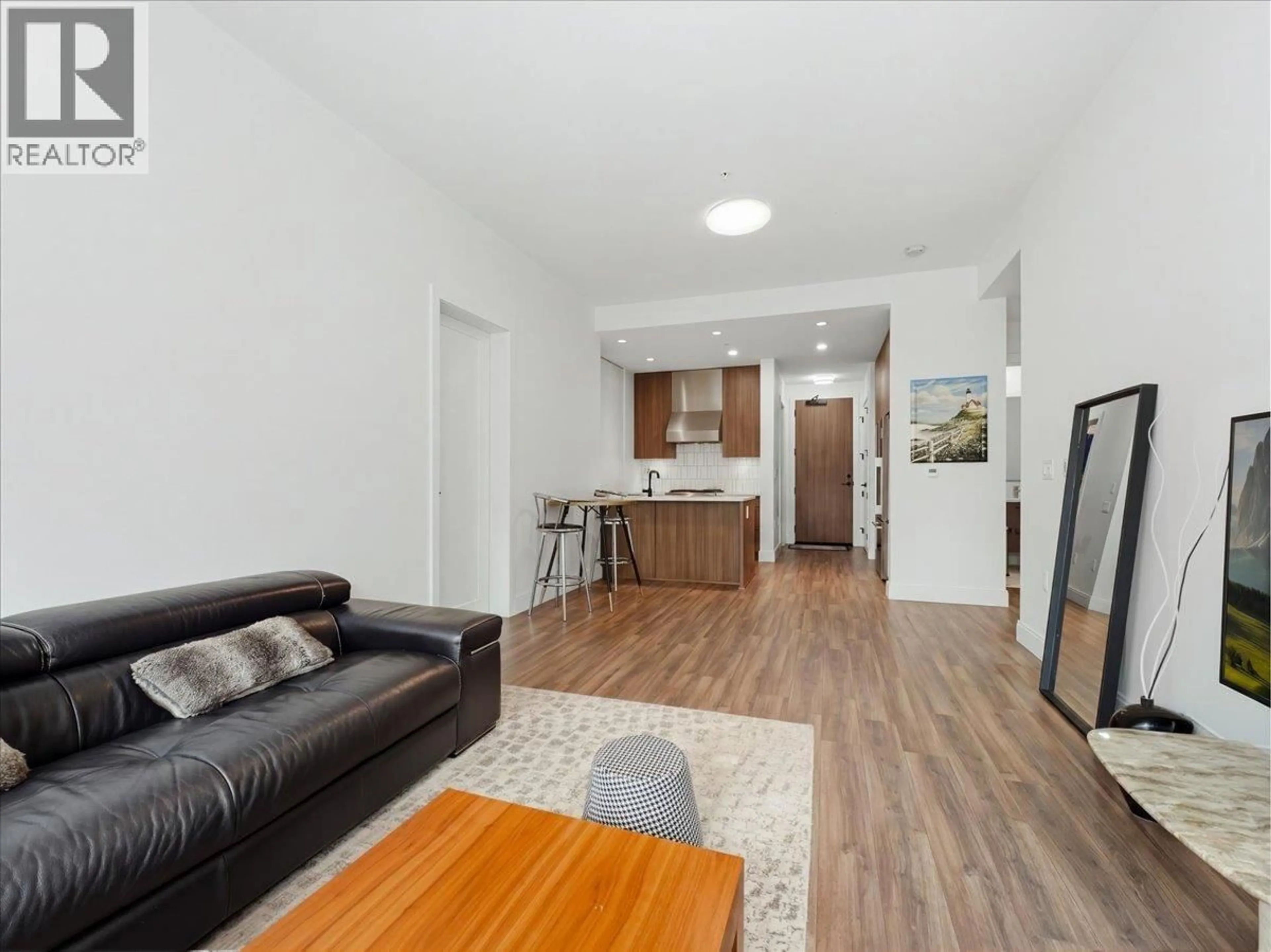 Living room with furniture, wood/laminate floor for 203 - 6999 CAMBIE STREET, Vancouver British Columbia V6P0J1