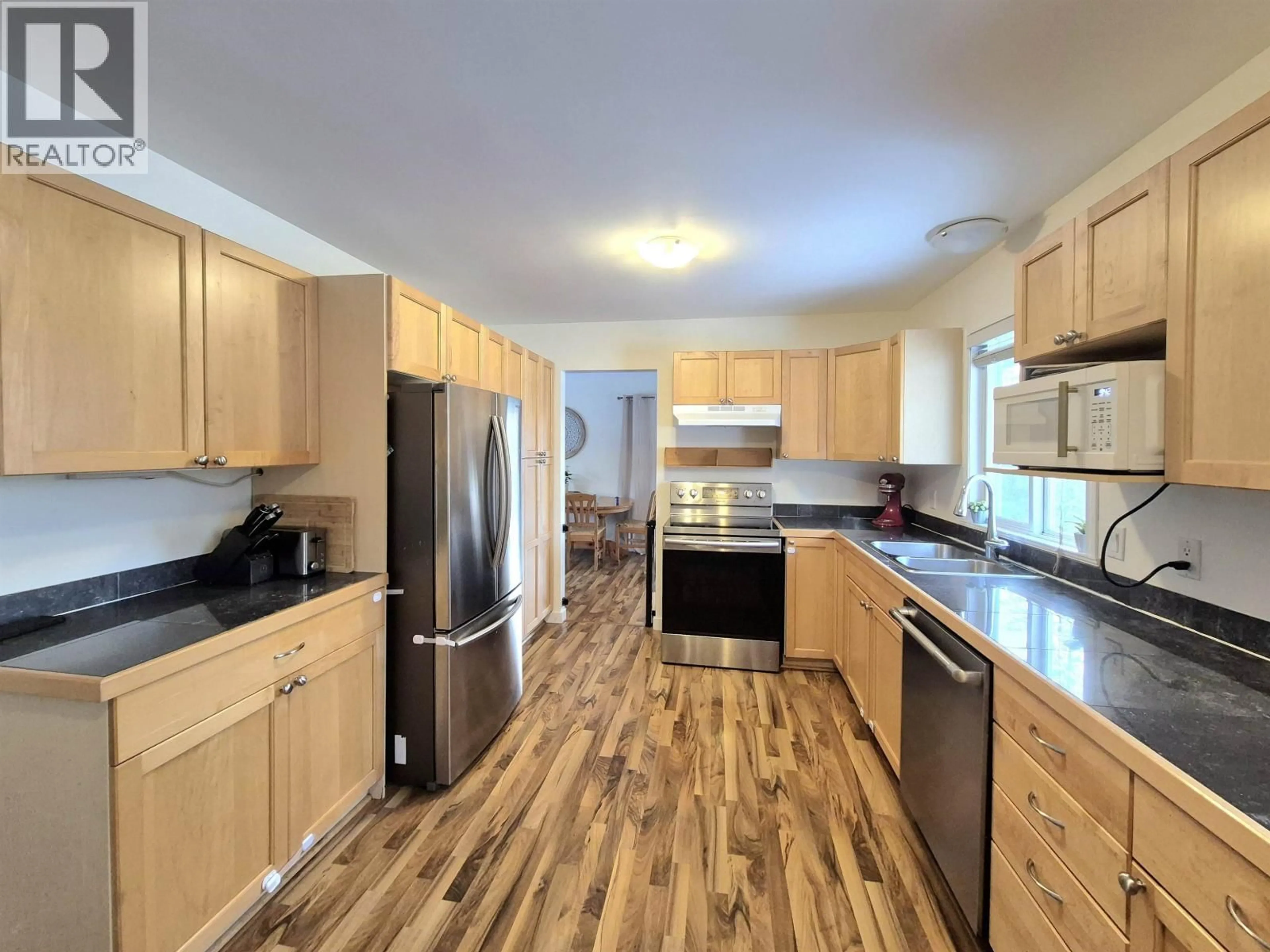 Open concept kitchen, wood/laminate floor for 4765 CHILCOTIN CRESCENT, 108 Mile Ranch British Columbia V0K2Z0