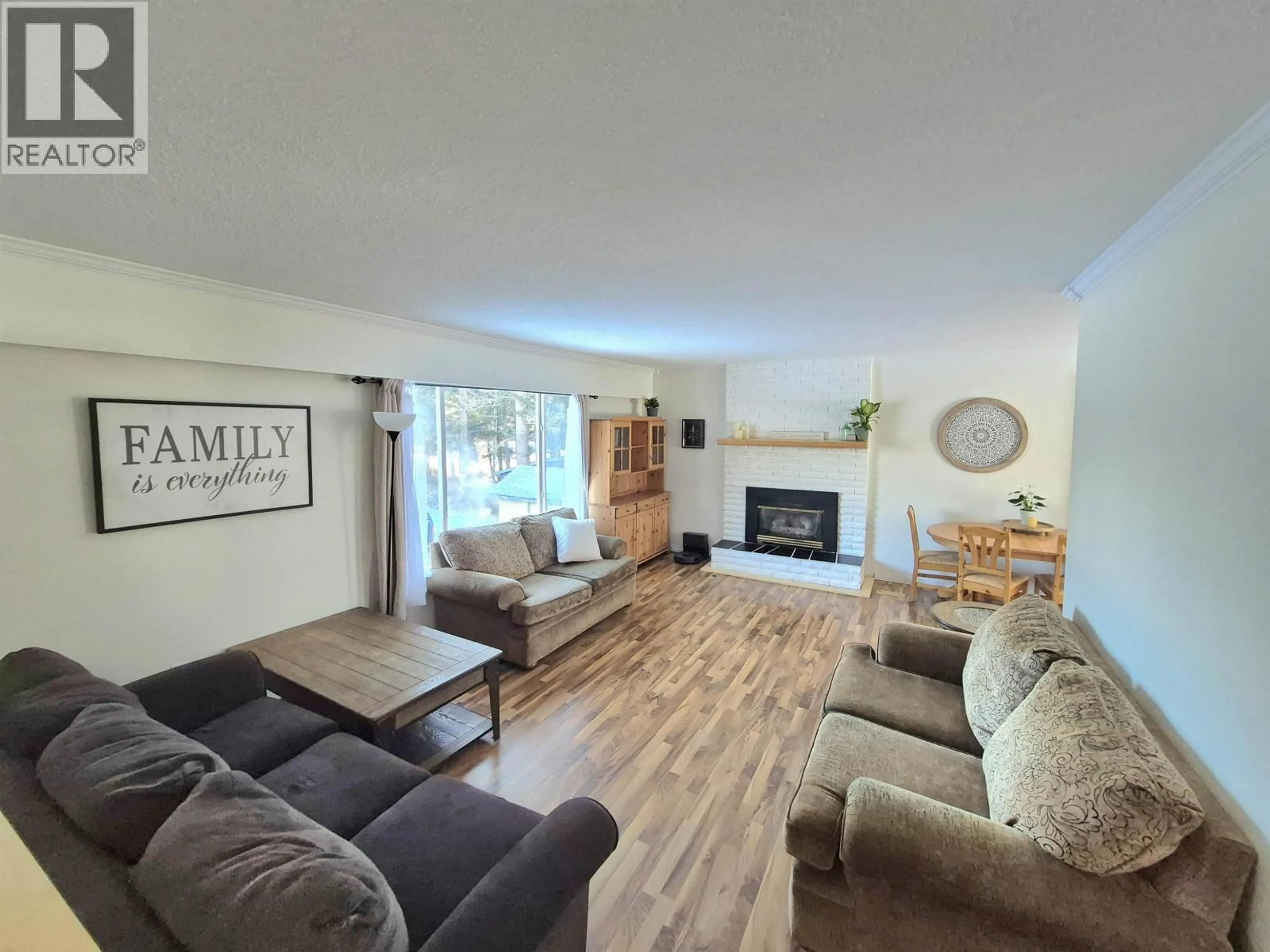 Living room with furniture, wood/laminate floor for 4765 CHILCOTIN CRESCENT, 108 Mile Ranch British Columbia V0K2Z0