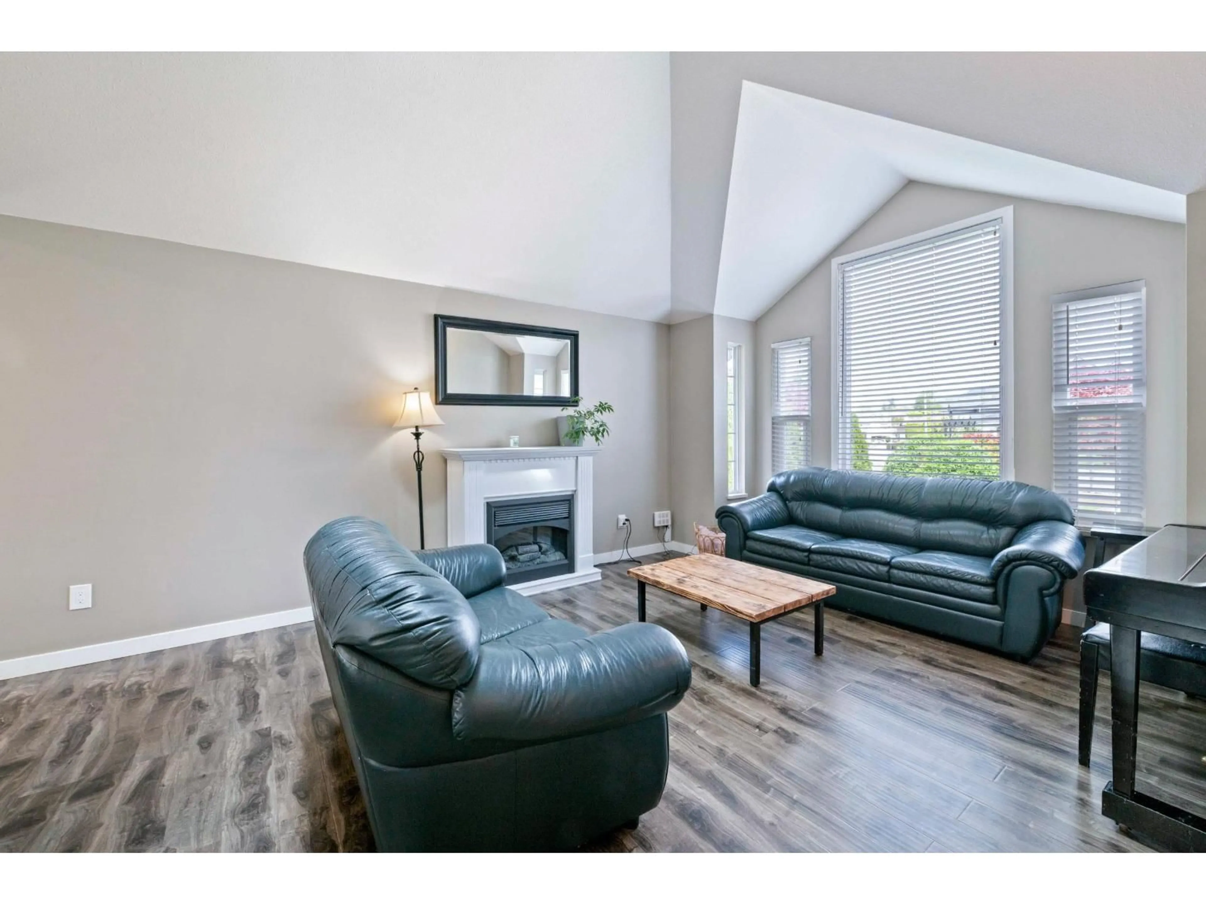 Living room with furniture, wood/laminate floor for 35408 LETHBRIDGE DRIVE, Abbotsford British Columbia V3G1J7