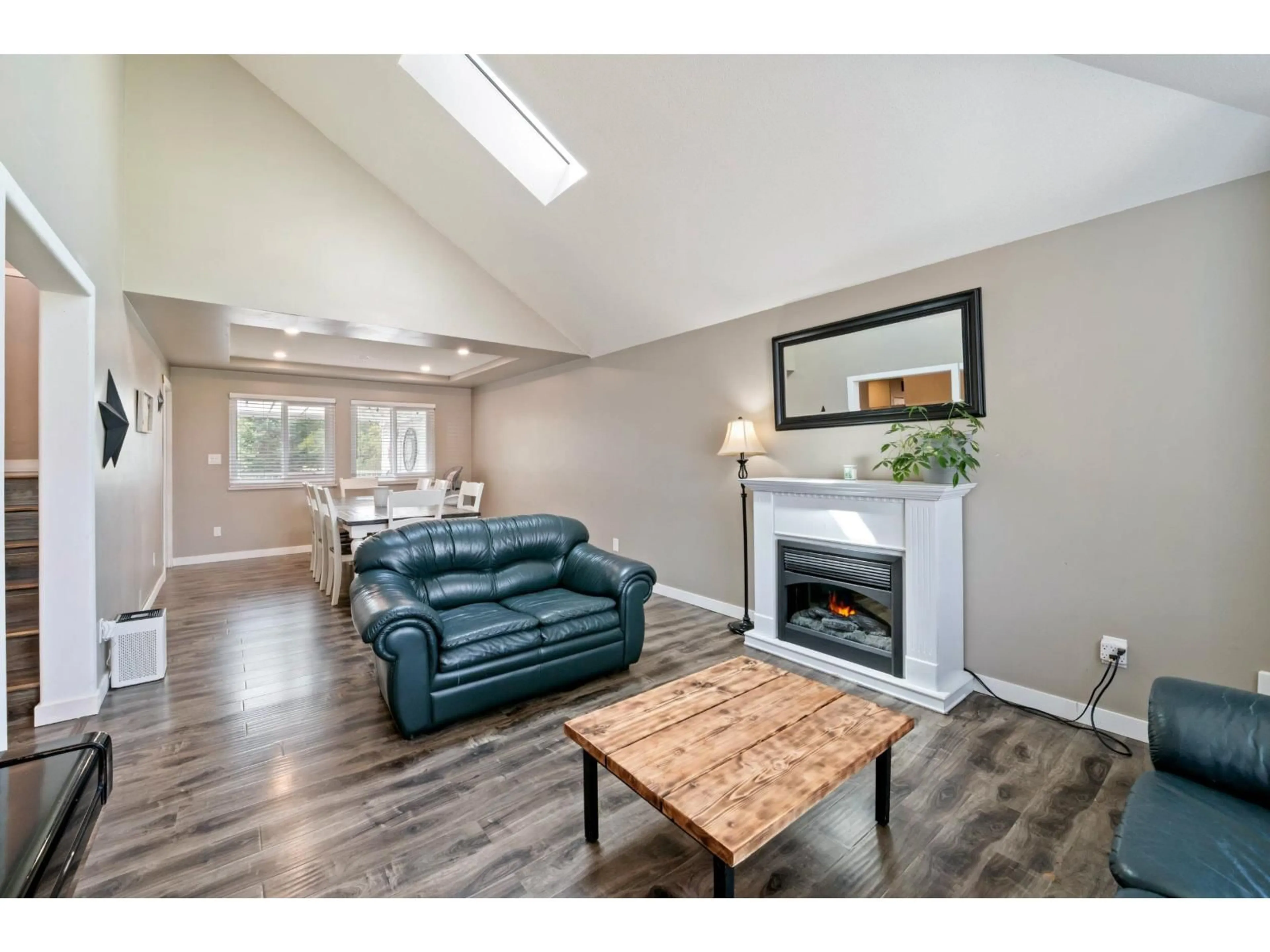 Living room with furniture, wood/laminate floor for 35408 LETHBRIDGE DRIVE, Abbotsford British Columbia V3G1J7