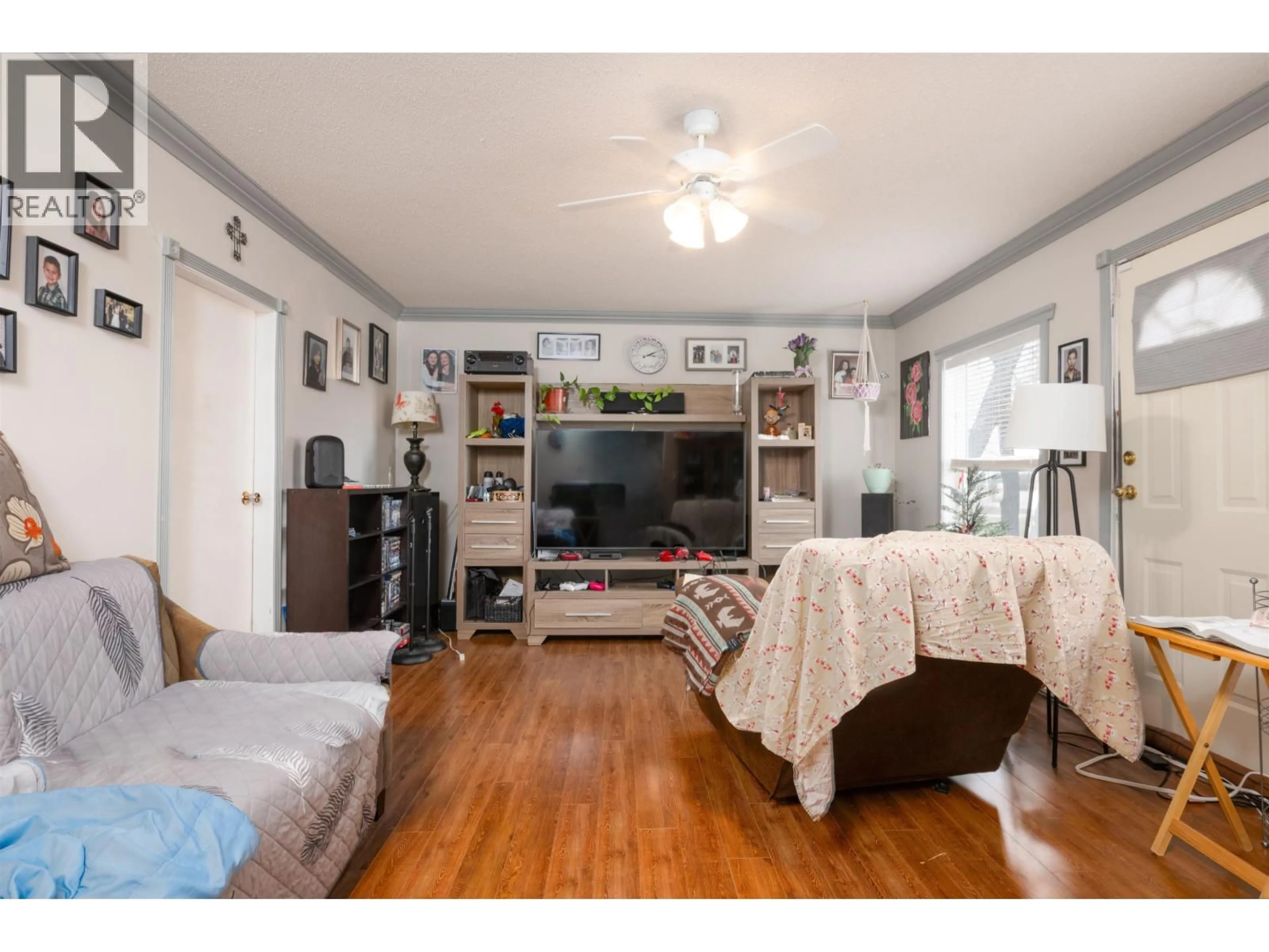 Living room with furniture, wood/laminate floor for 3610 BLACKBURN ROAD, Prince George British Columbia V2N6C2