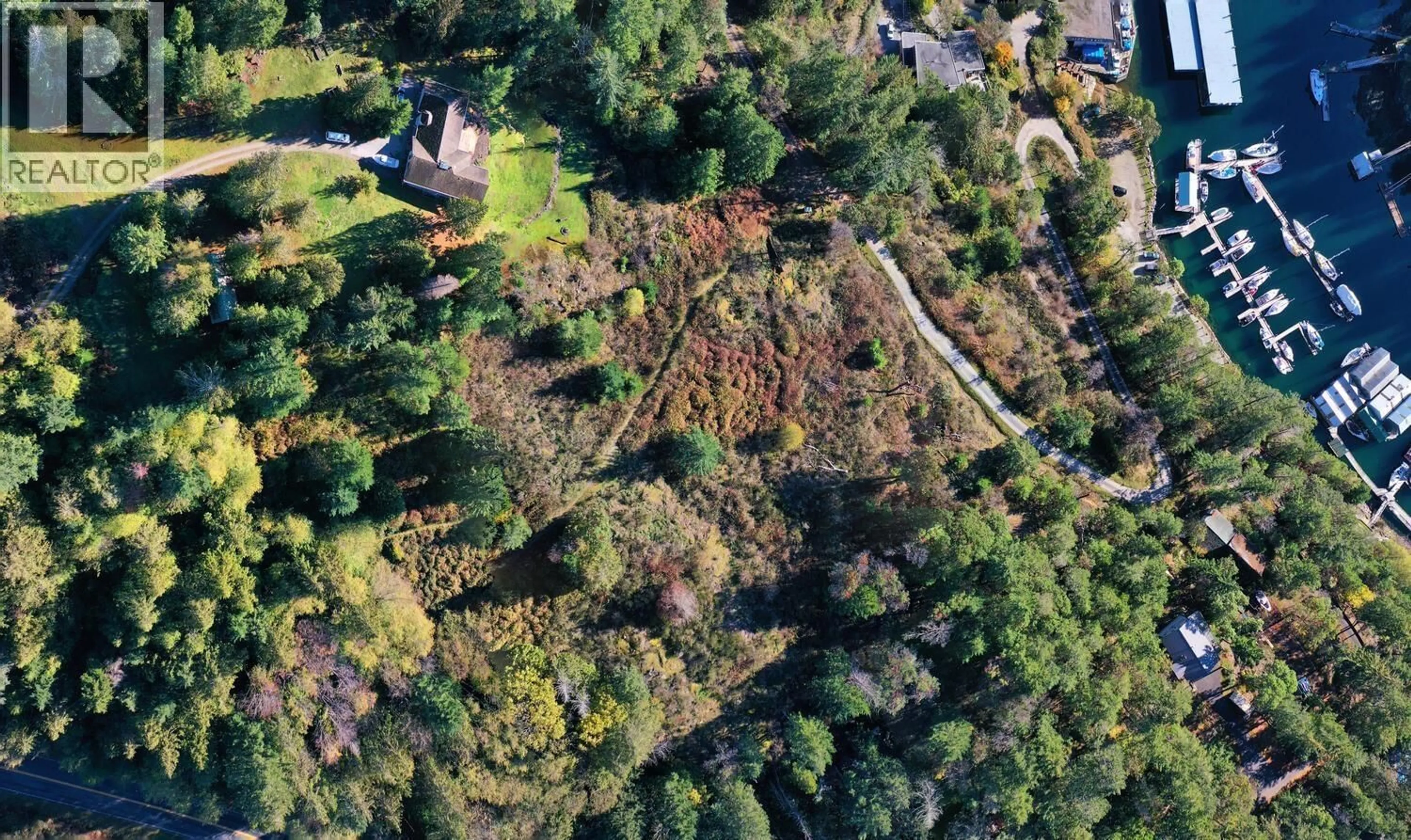 A pic from outside/outdoor area/front of a property/back of a property/a pic from drone, forest/trees view for 10113 - 10131 MERCER ROAD, Halfmoon Bay British Columbia V7Z1B7