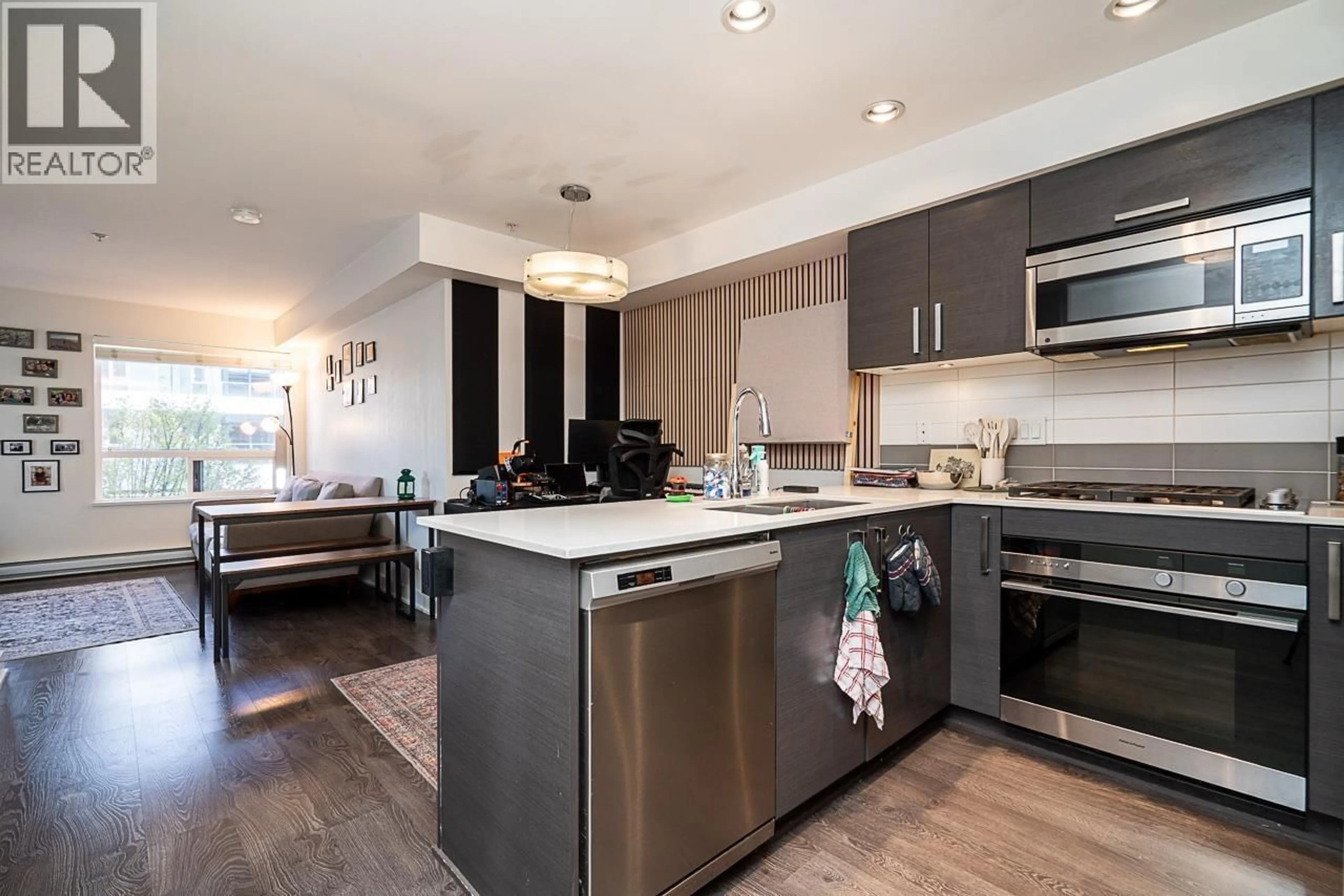 Open concept kitchen, wood/laminate floor for 212 - 2858 4TH AVENUE, Vancouver British Columbia V6K1R2